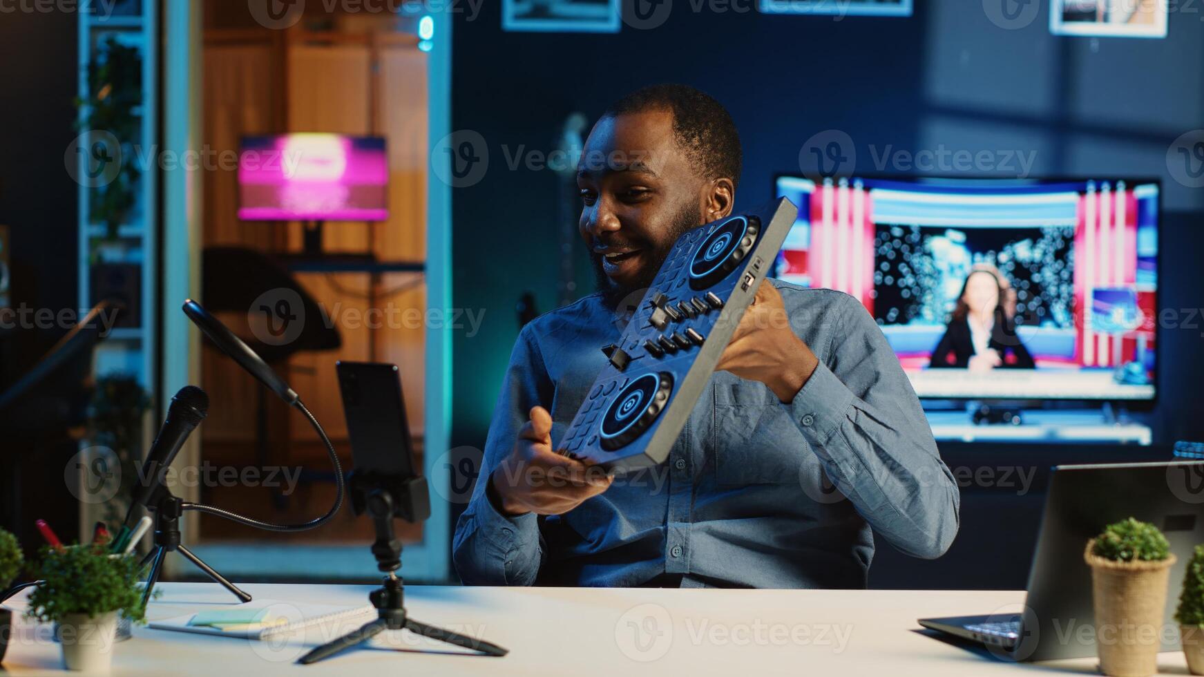 Content creator filming technology review of newly released DJ controller, unboxing it and presenting specifications to audience. Influencer showing sound mixer equipment to followers photo