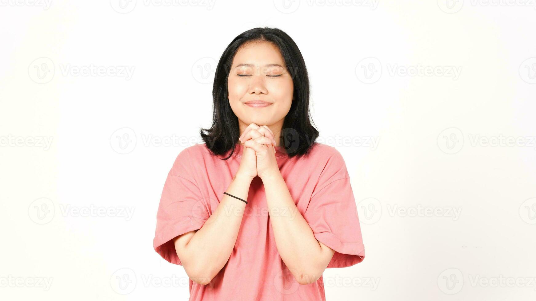 Closed eyes and holding hand for pray Of Beautiful Asian Woman Isolated On White Background photo