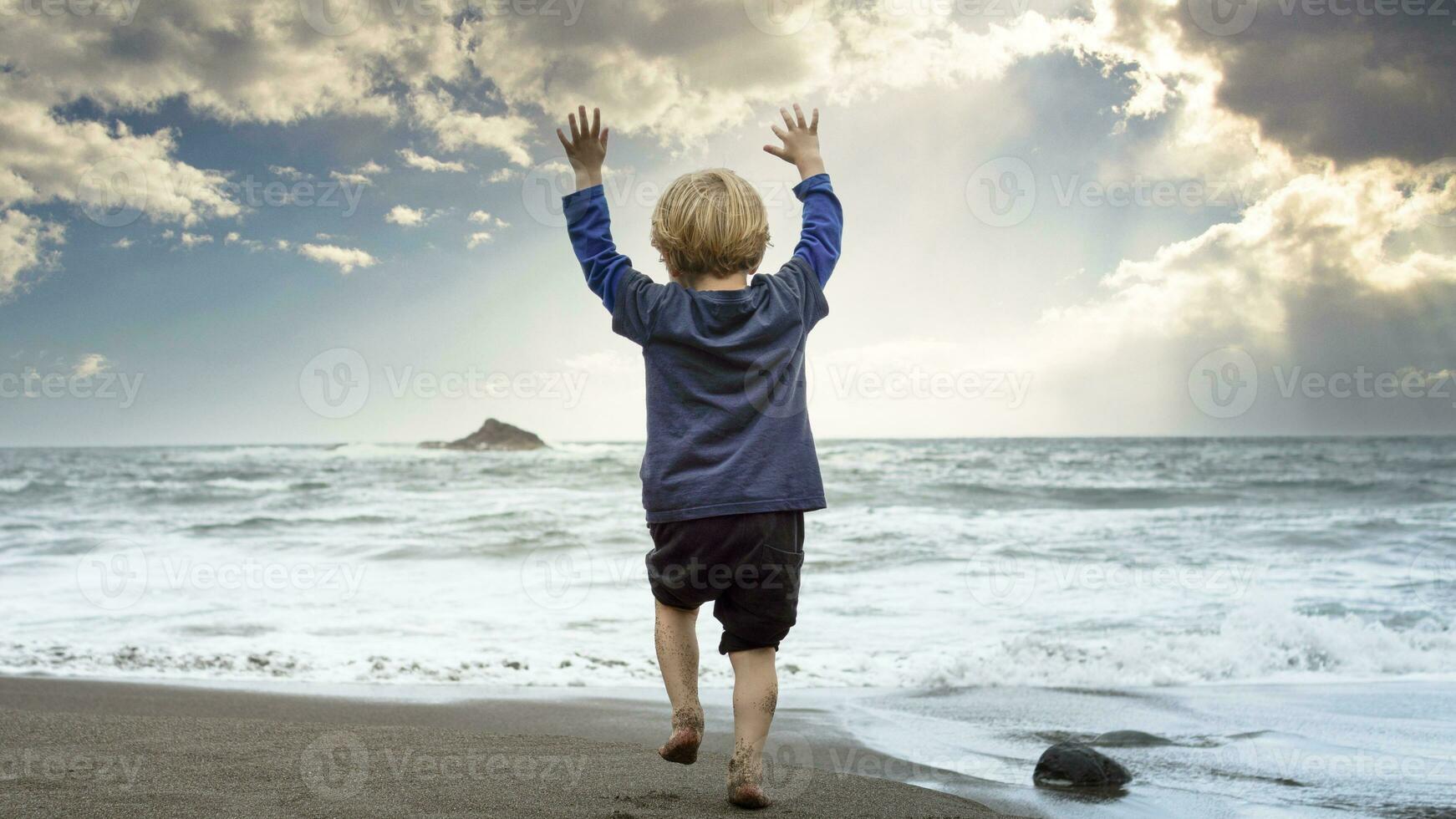 Small child playing on the beach photo