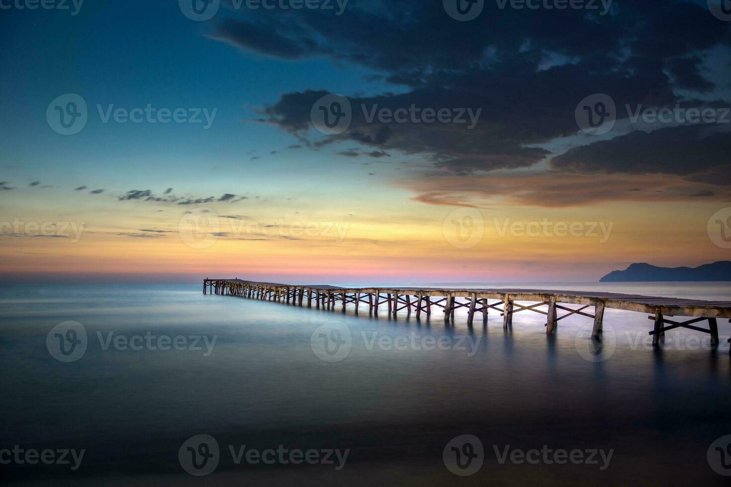 Wooden pier on the east coast of Mallorca at sunrise photo