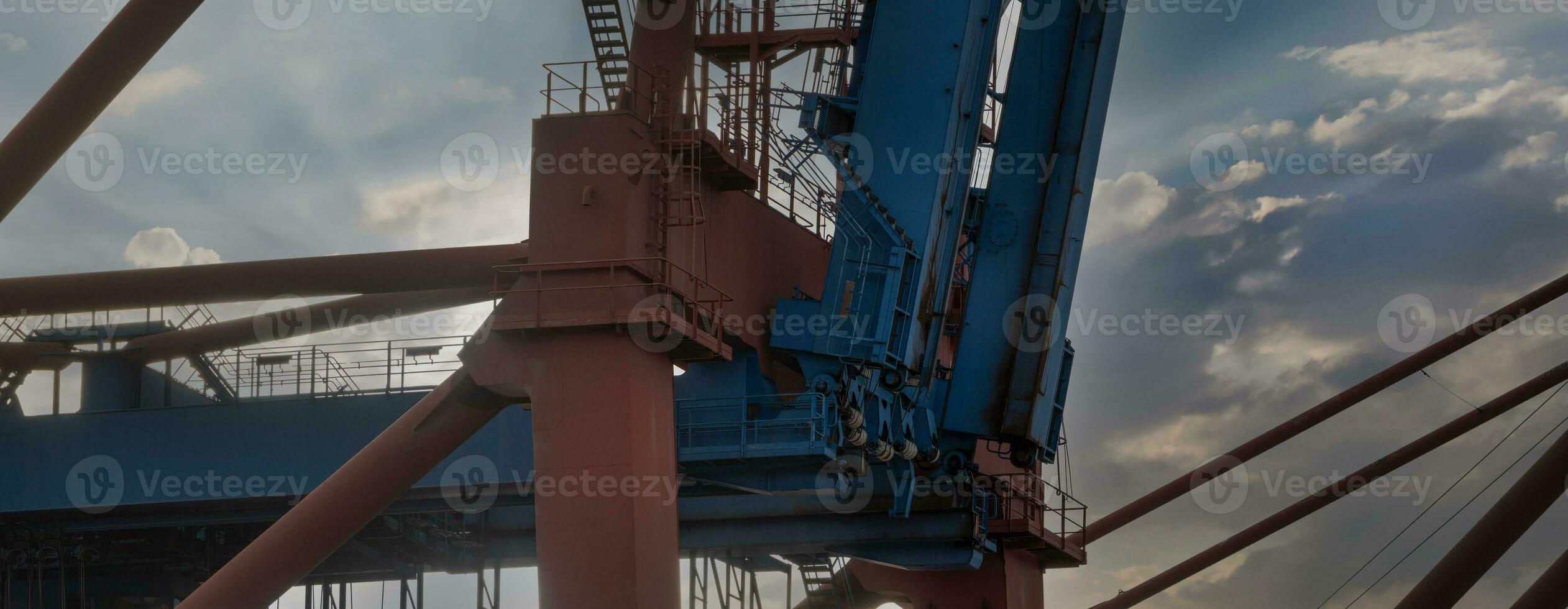 part of a container bridge in the port of hamburg at sunset photo