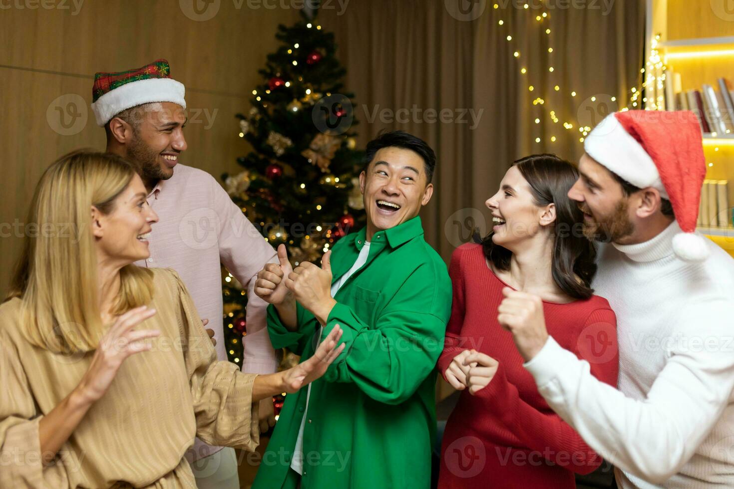 Group friends celebrate New Year's party at home, dancing together Christmas eve having fun. house New Year party. spending Time Together ,Holidays Mood funny man and woman. photo