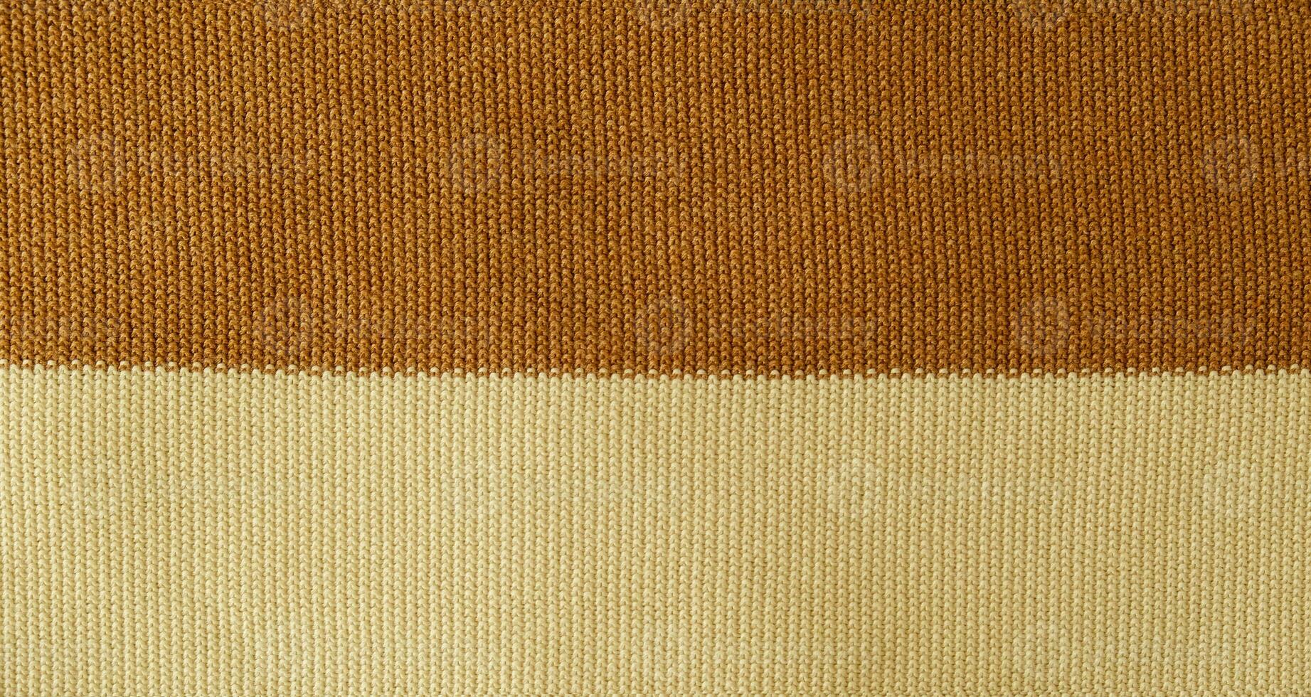 Texture of smooth knitted sweater with pattern. Top view, close-up. Handmade knitting wool or cotton fabric texture. Background of knitting patterns front and back stitch. photo