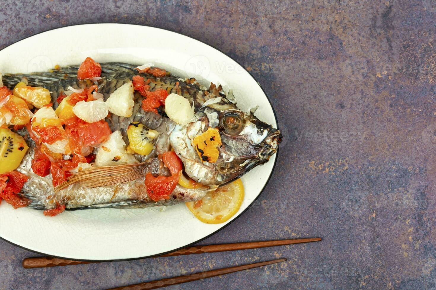 Roasted whole tilapia with citrus sauce. photo