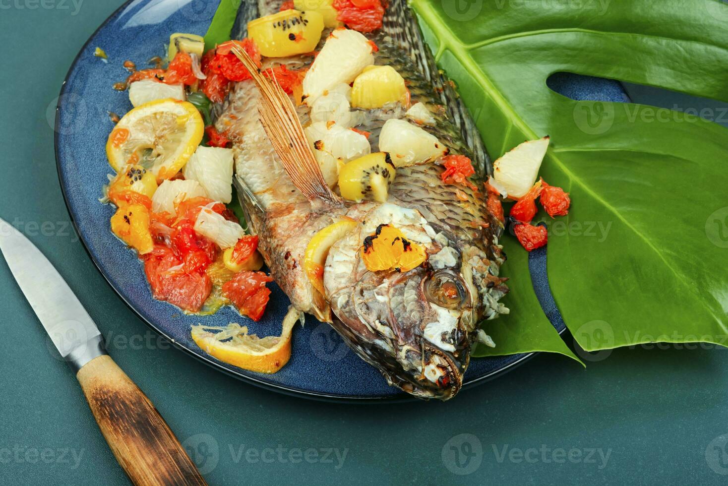 Roasted whole tilapia with citrus sauce. photo