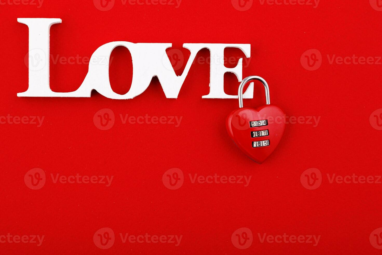 inscription love and red hearts on a red background photo