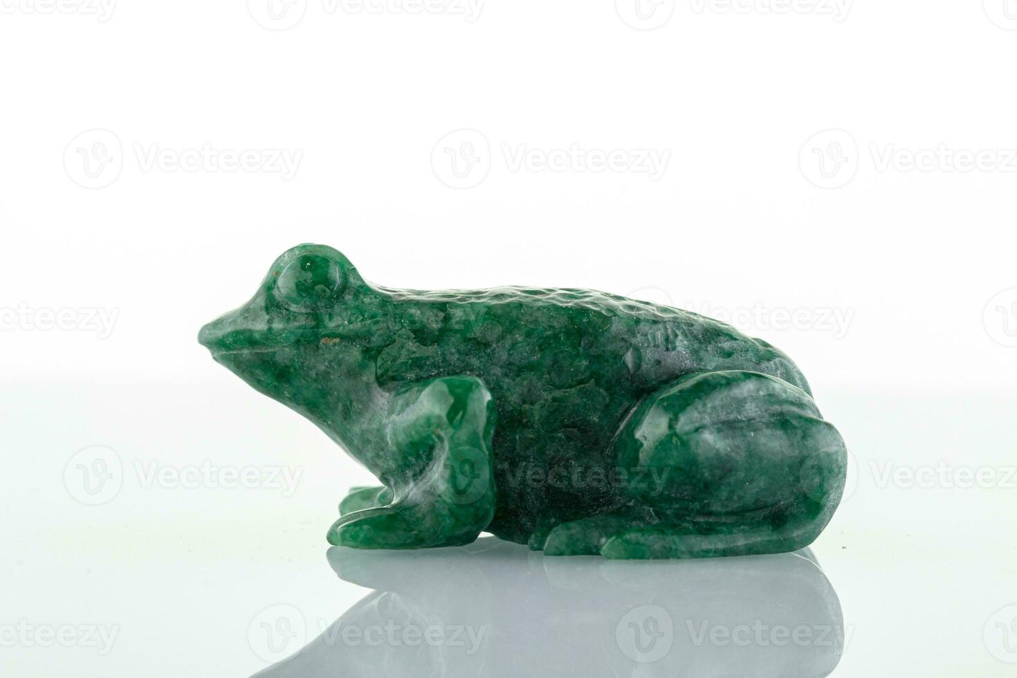 beautiful figurine of a toad made of malachite on a white background photo