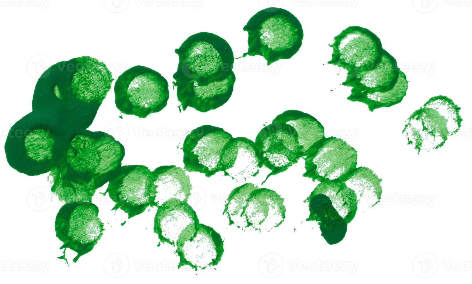 Drawn dots with acrylic green paint on a white isolated background photo