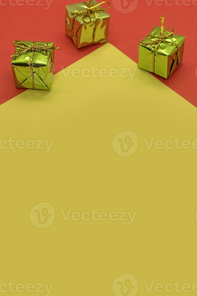 Christmas background with gift boxes on red and yellow background. Top view. photo
