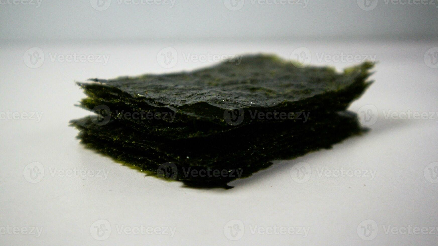 Crispy nori seaweed on white background. Japanese dry seaweed sheets. photo