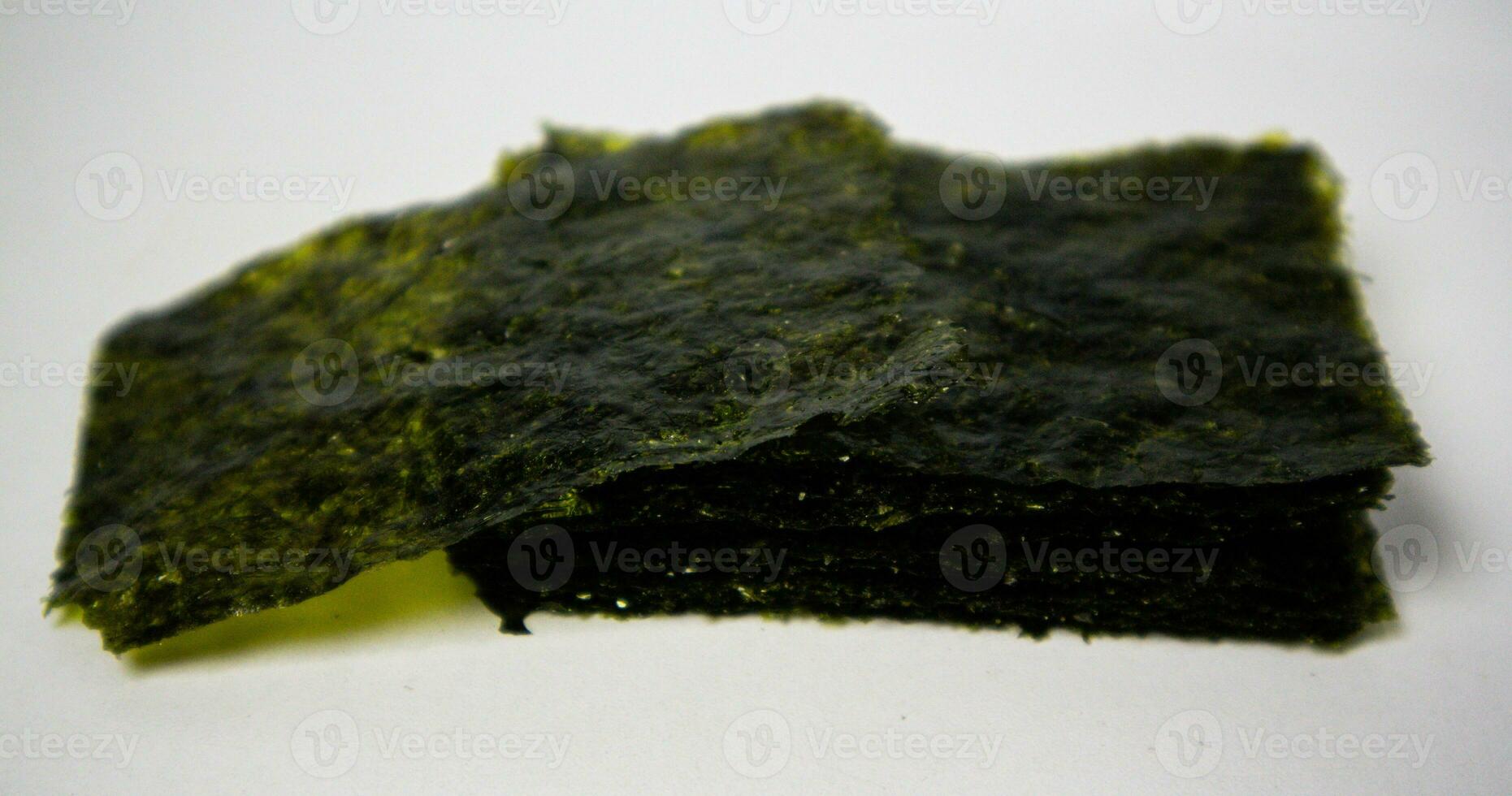 Crispy nori seaweed on white background. Japanese dry seaweed sheets. photo