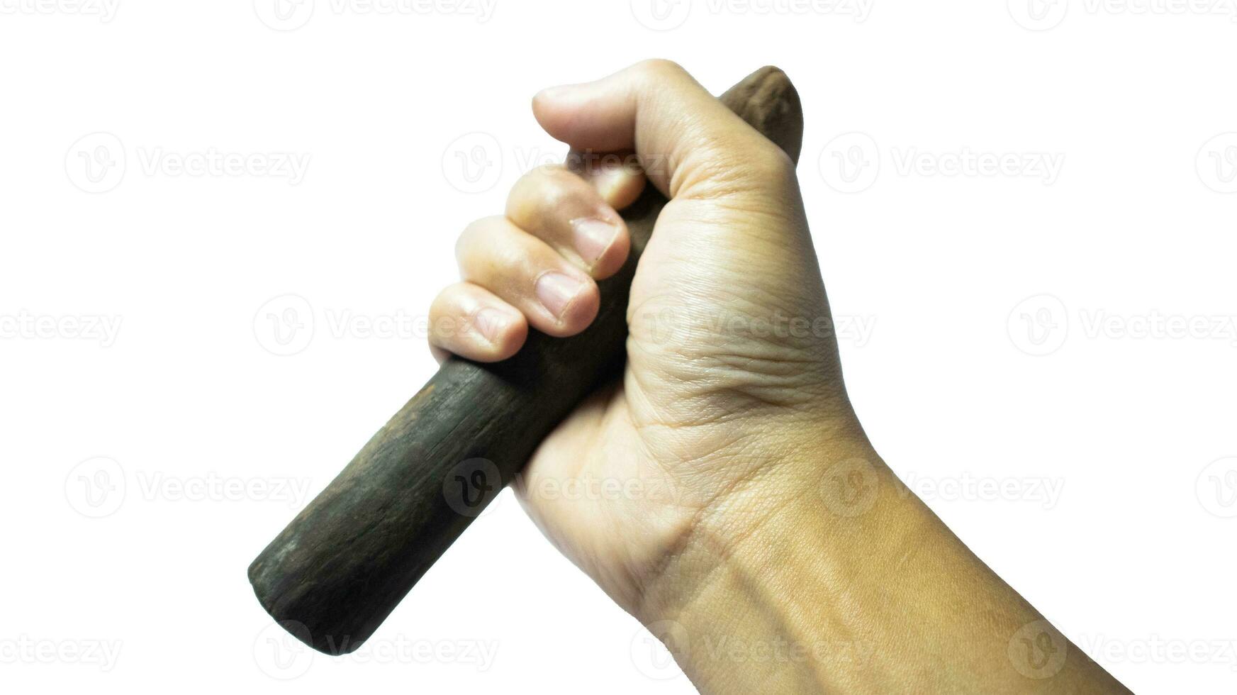 Man Hand holding a wooden pestle isolated on white background photo