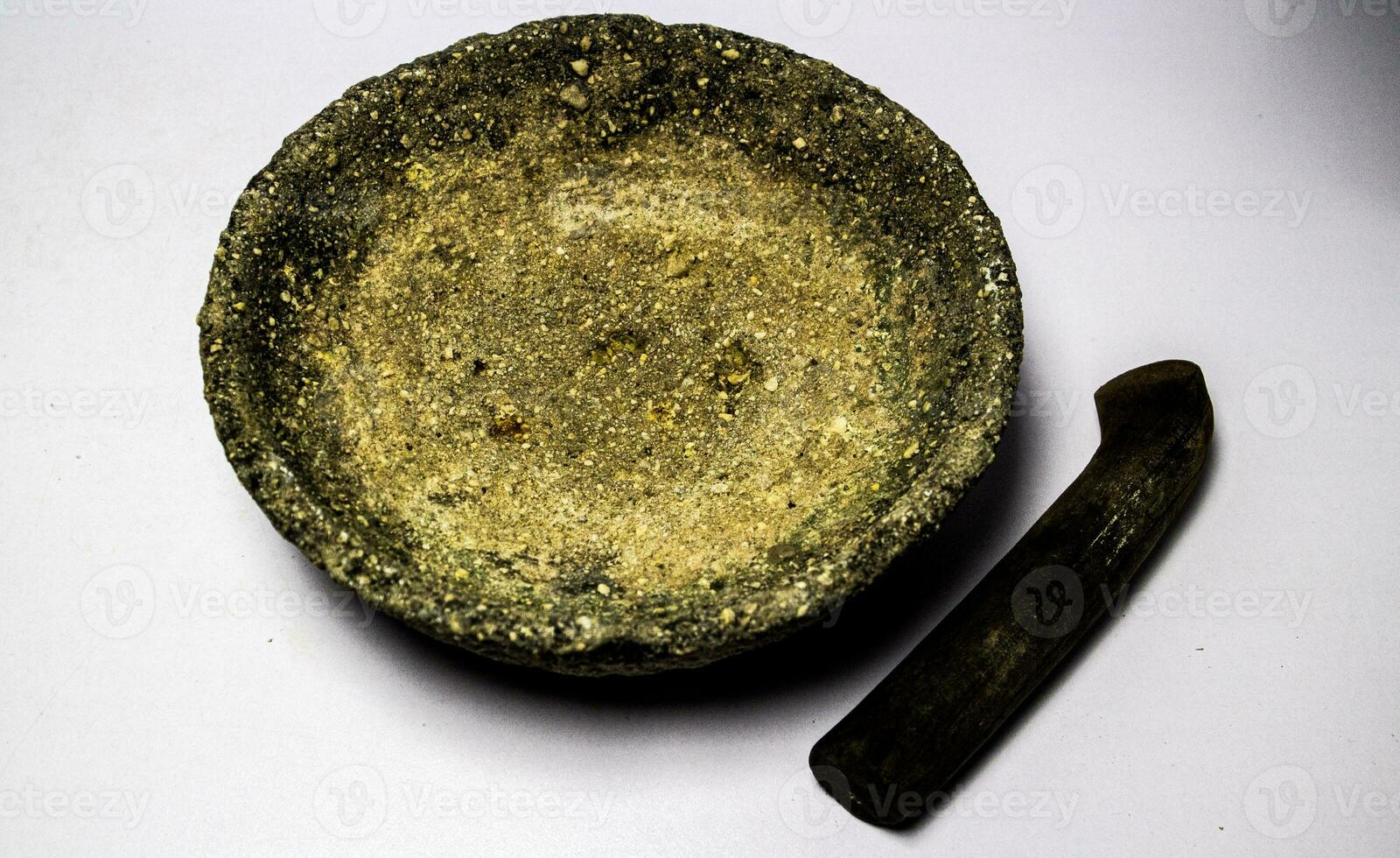 Granite mortar and pestle isolated on a white background. photo