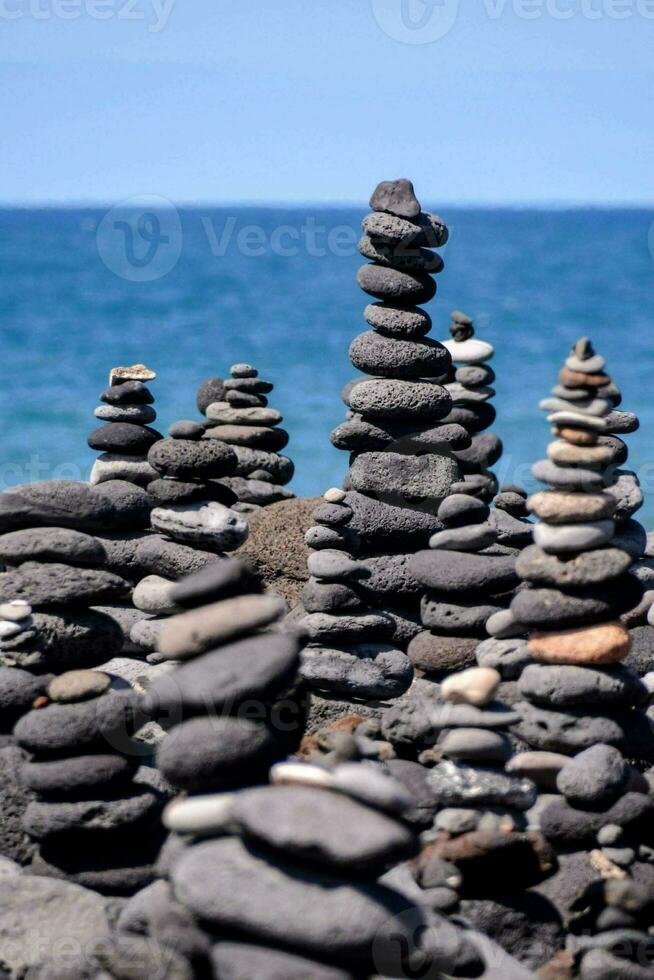 stacked rocks on the beach photo