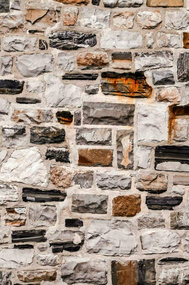 a stone wall with many different colors and textures photo