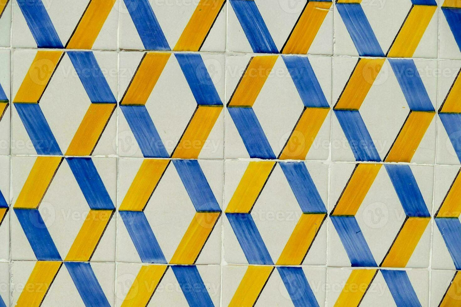 a blue and yellow tile wall with geometric shapes photo