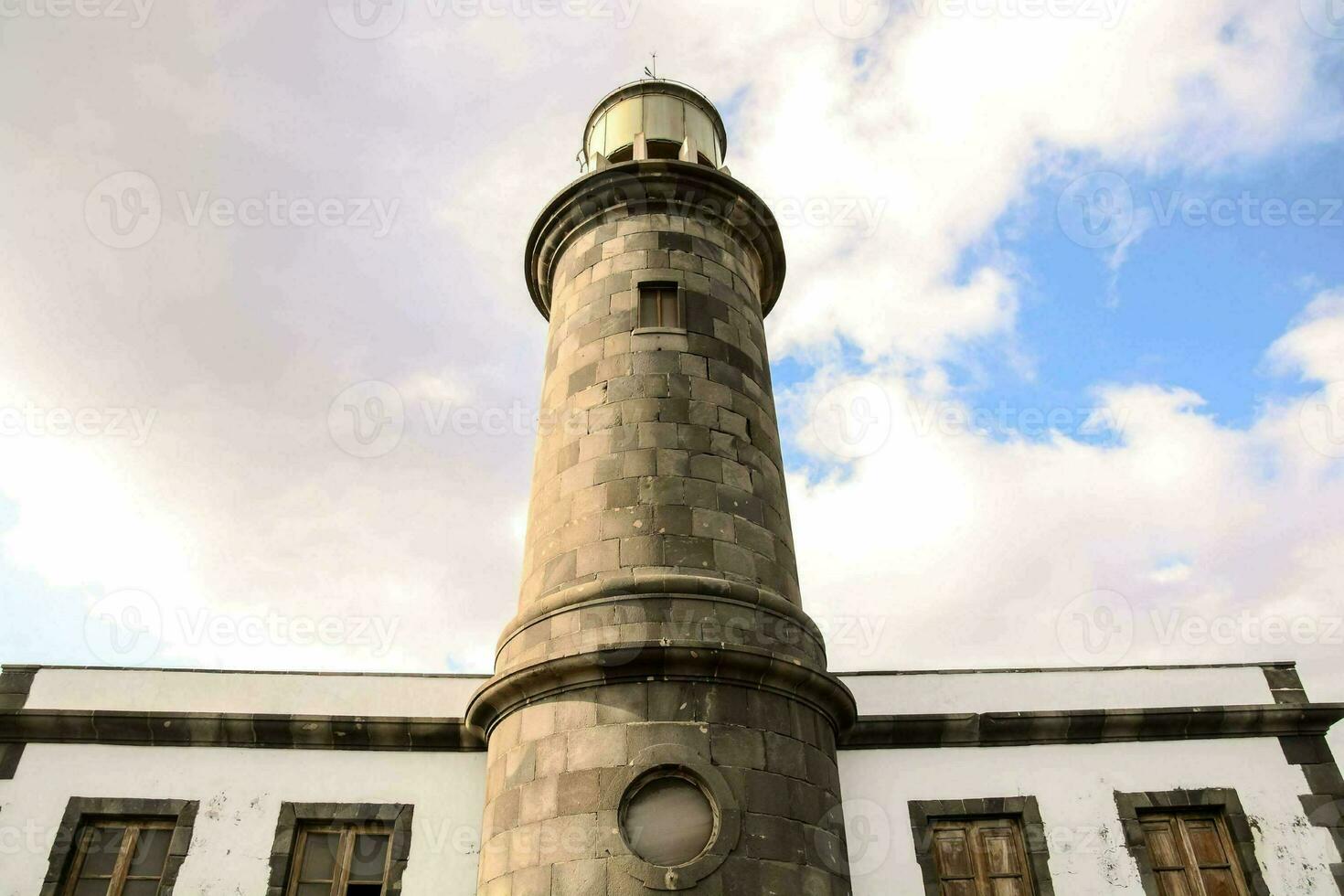 a lighthouse tower in the middle of a white building photo