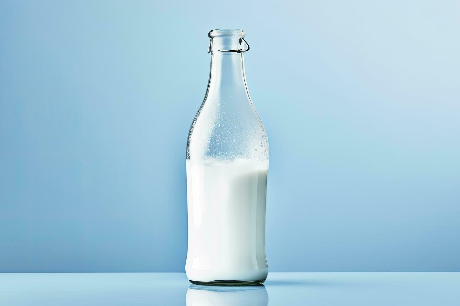 AI generated A glass bottle with full milk on blue background. photo