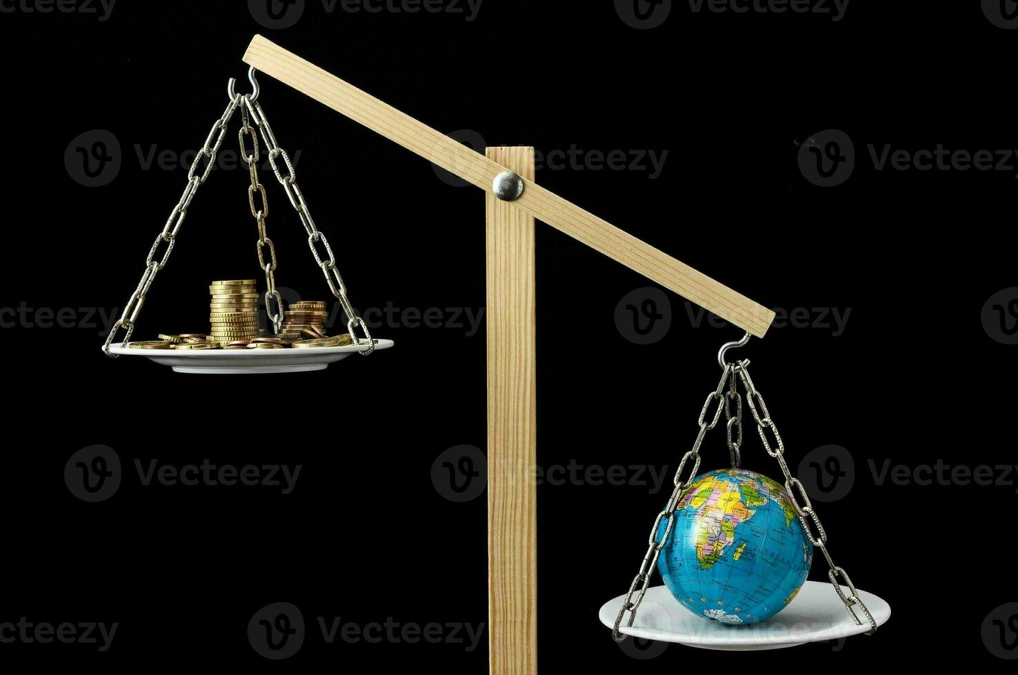 a balance scale with a globe and coins on it photo