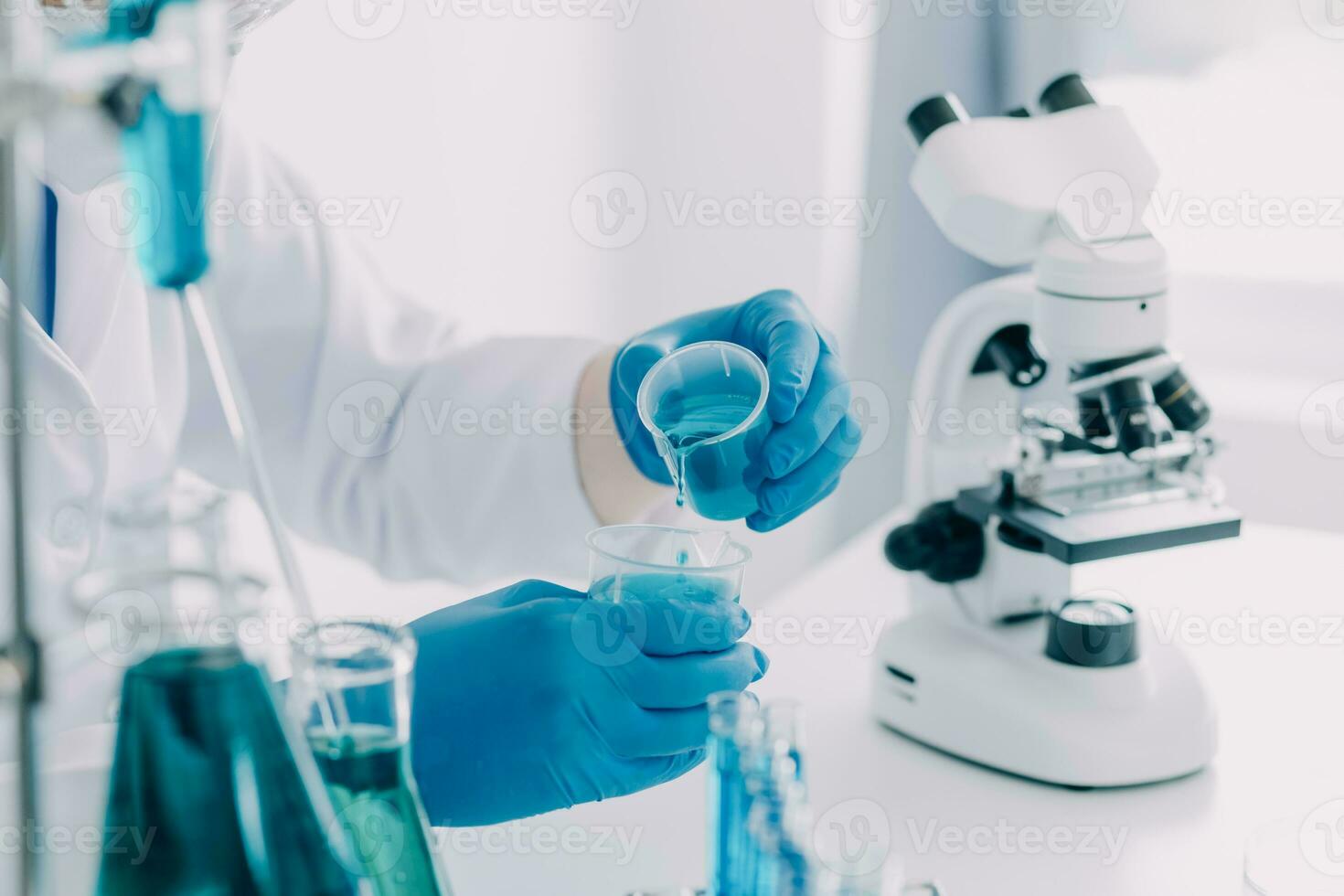 microscope with lab glassware, science laboratory research and development concept photo