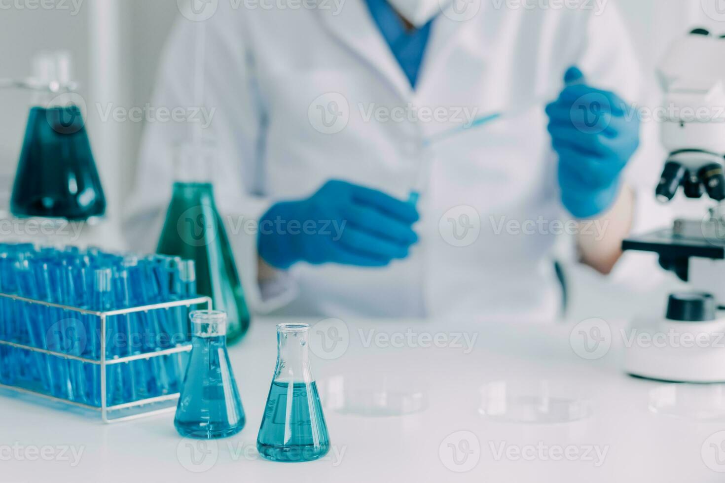 microscope with lab glassware, science laboratory research and development concept photo
