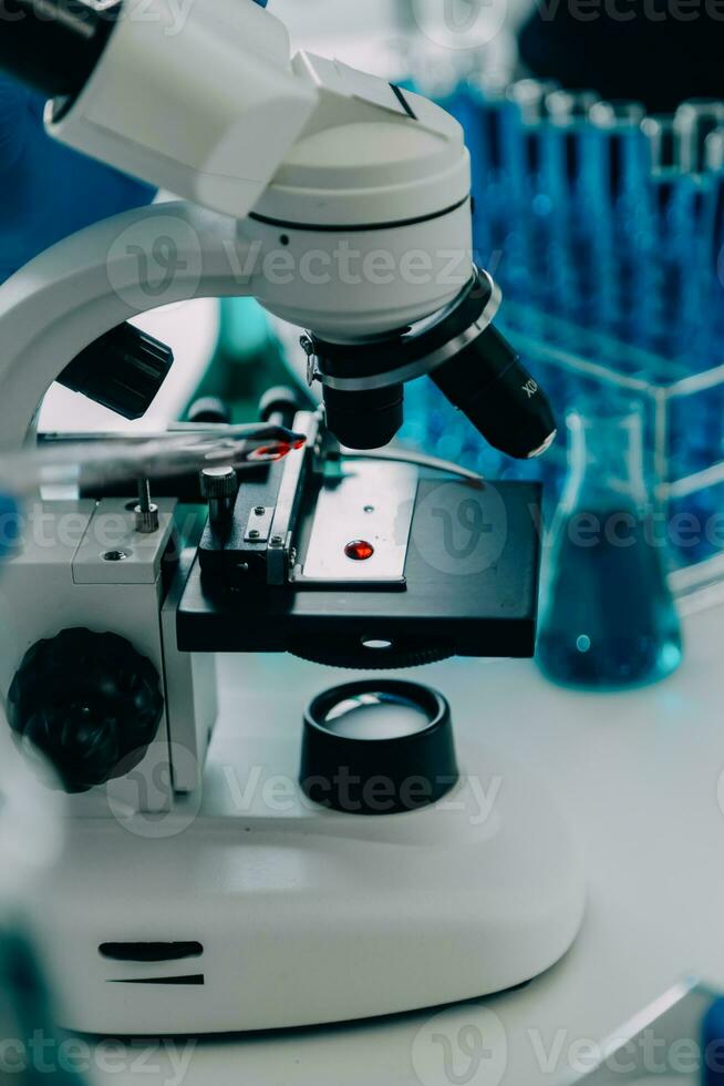 microscope with lab glassware, science laboratory research and development concept photo