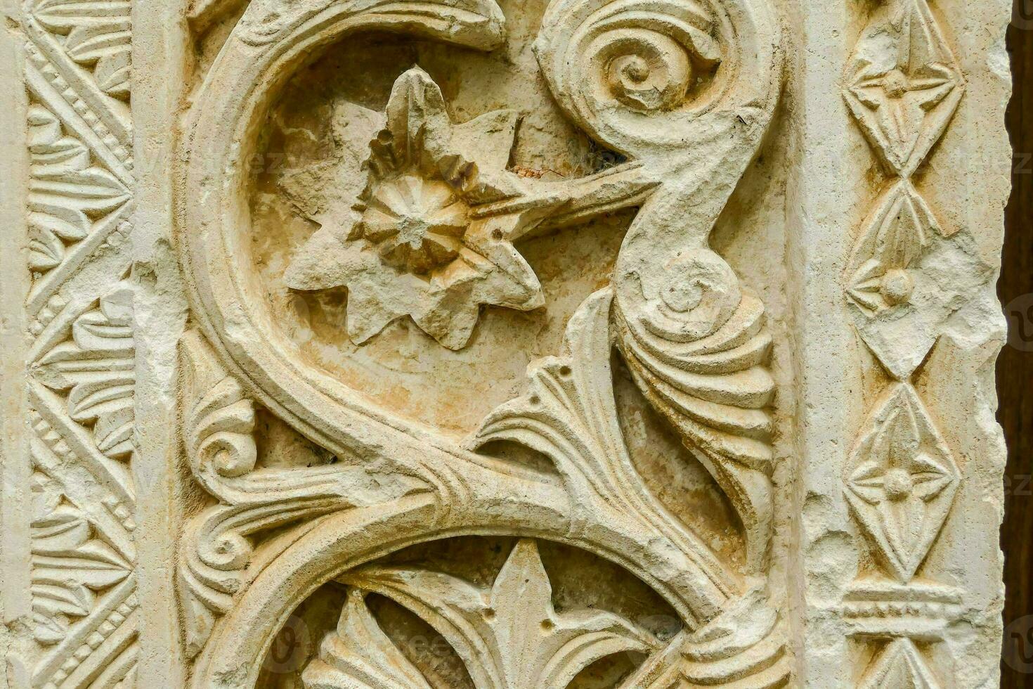 an ornate carving on a wall in a building photo