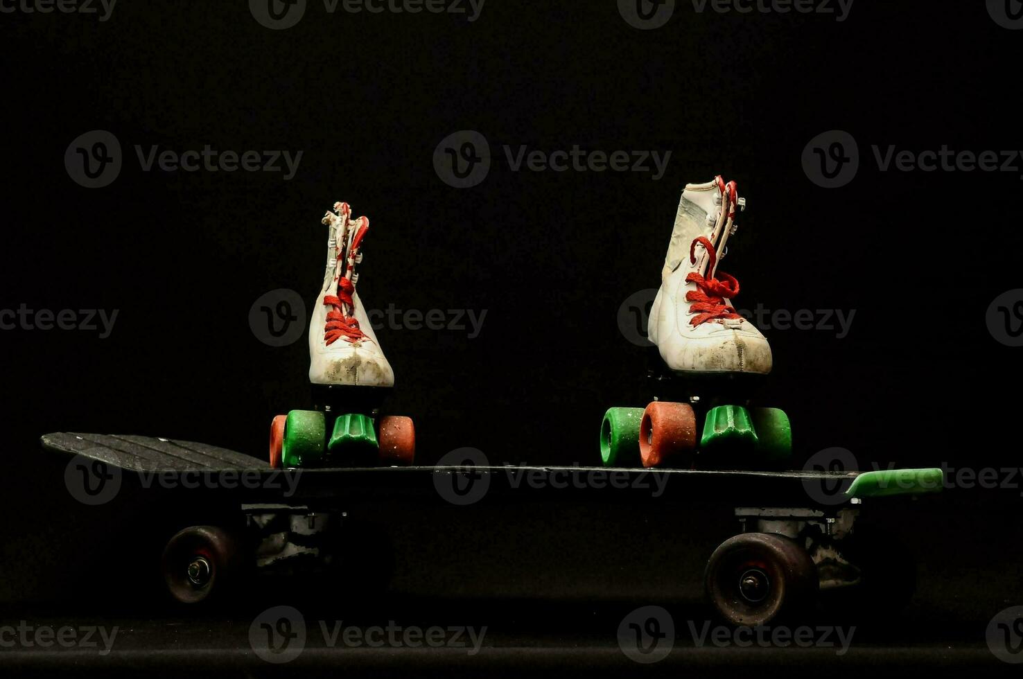 two pairs of roller skates on a skateboard photo