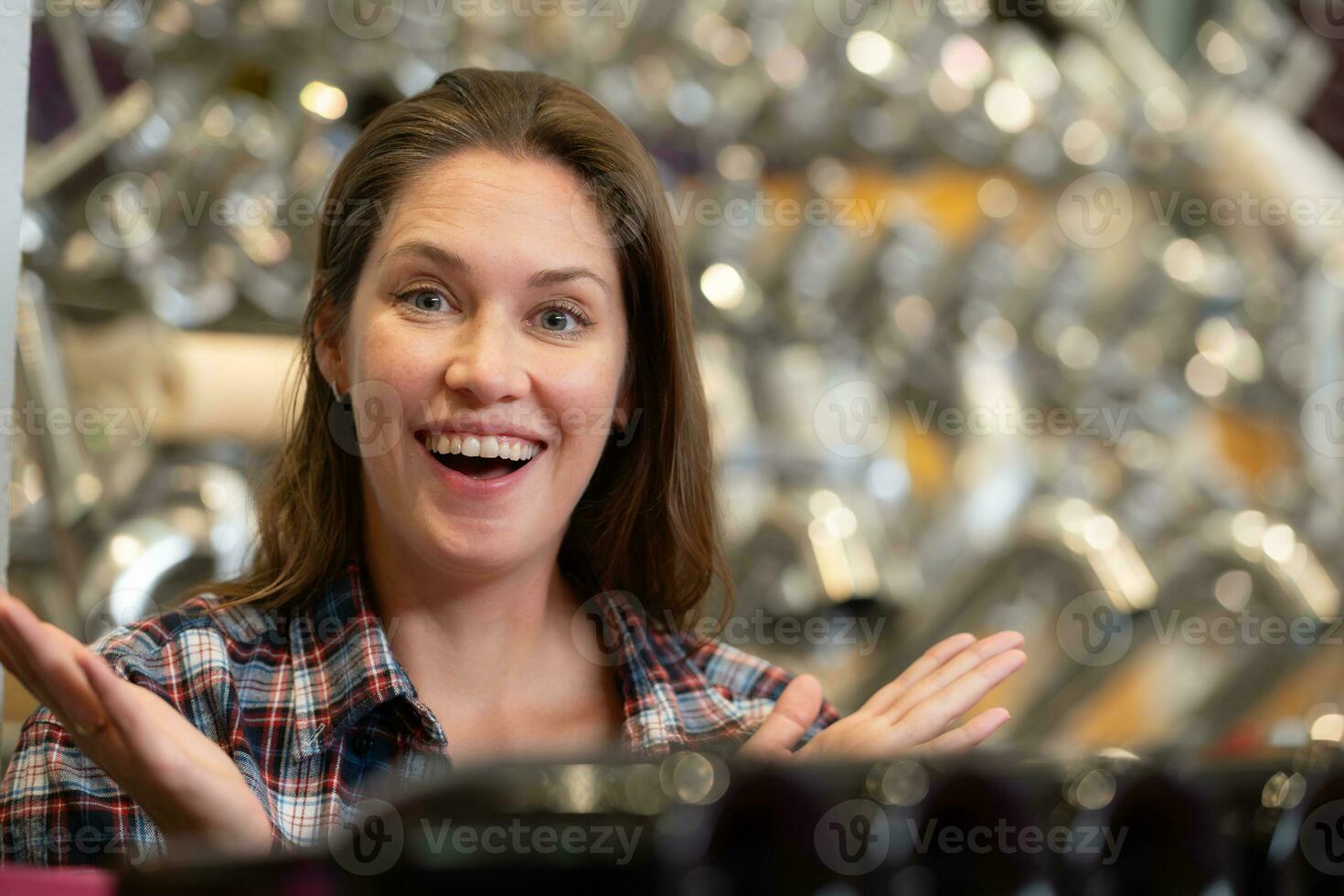 Woman looking at wine bottles in a wine store. Focus on woman photo