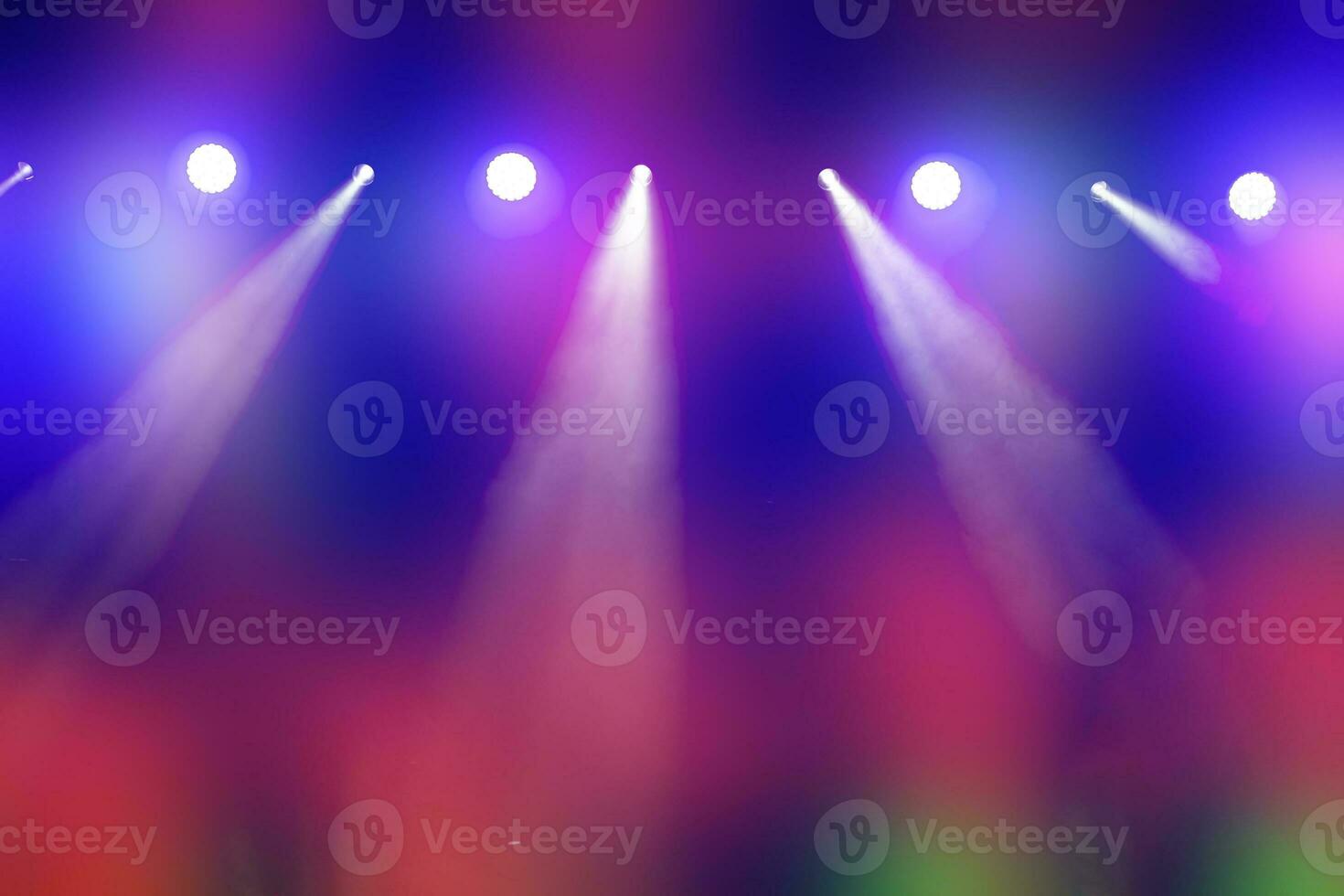 Bright multi-colored iridescent lights of stage lighting. Background scene, performance. Concert light. photo