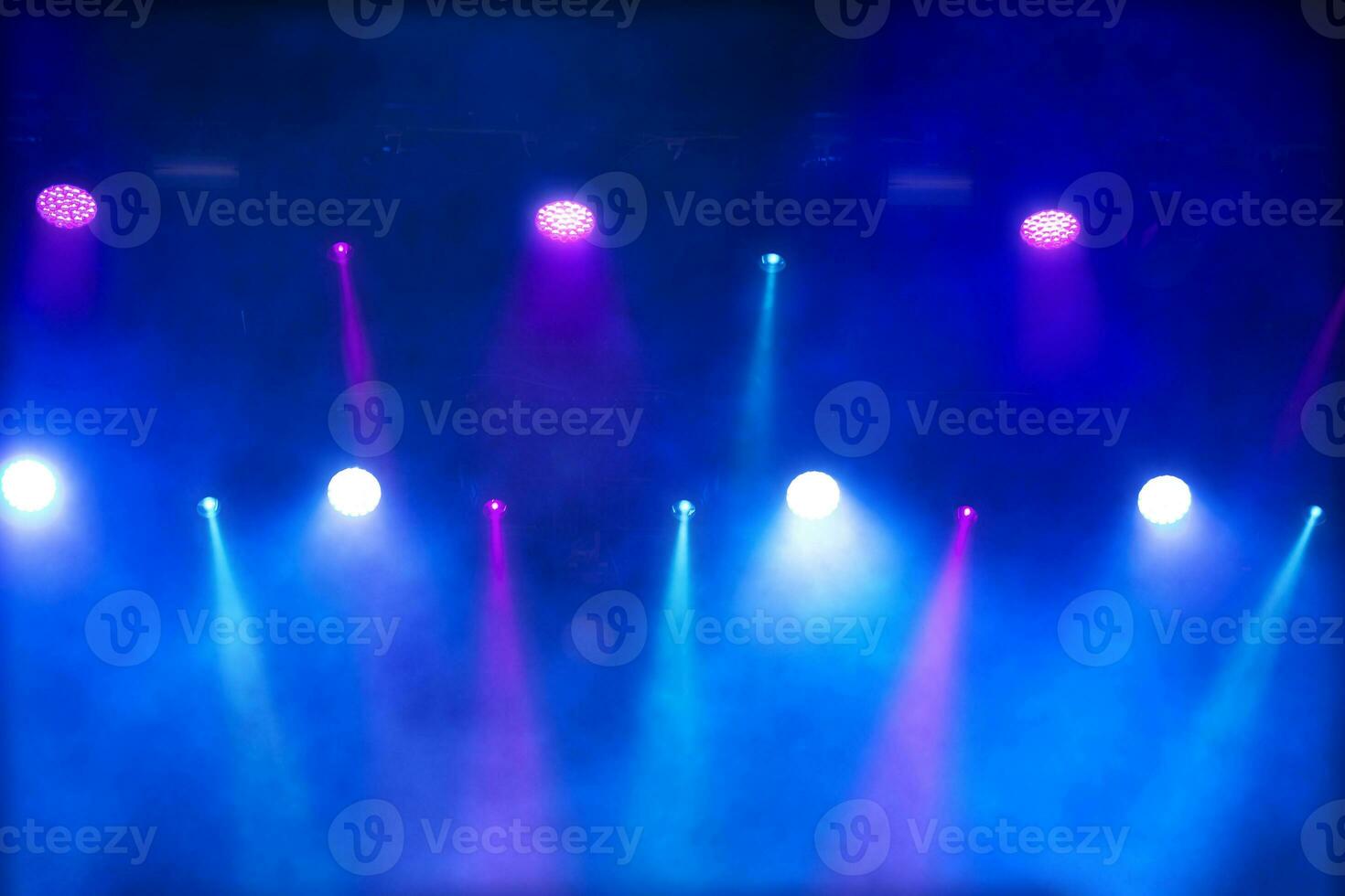 Bright multi-colored iridescent lights of stage lighting. Background scene, performance. Concert light. photo