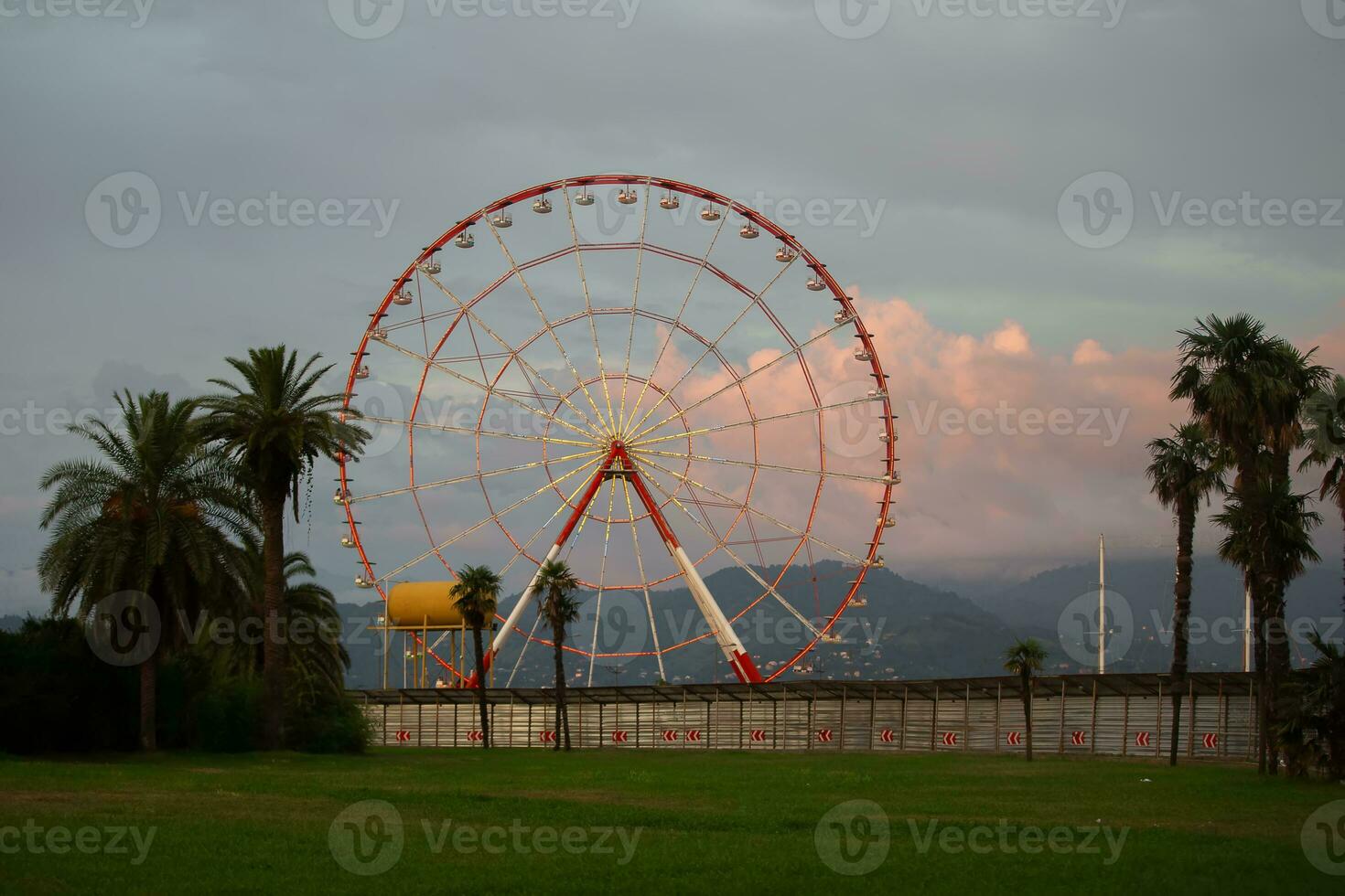 Retro ferris wheel carousel on the background of the evening sky. photo