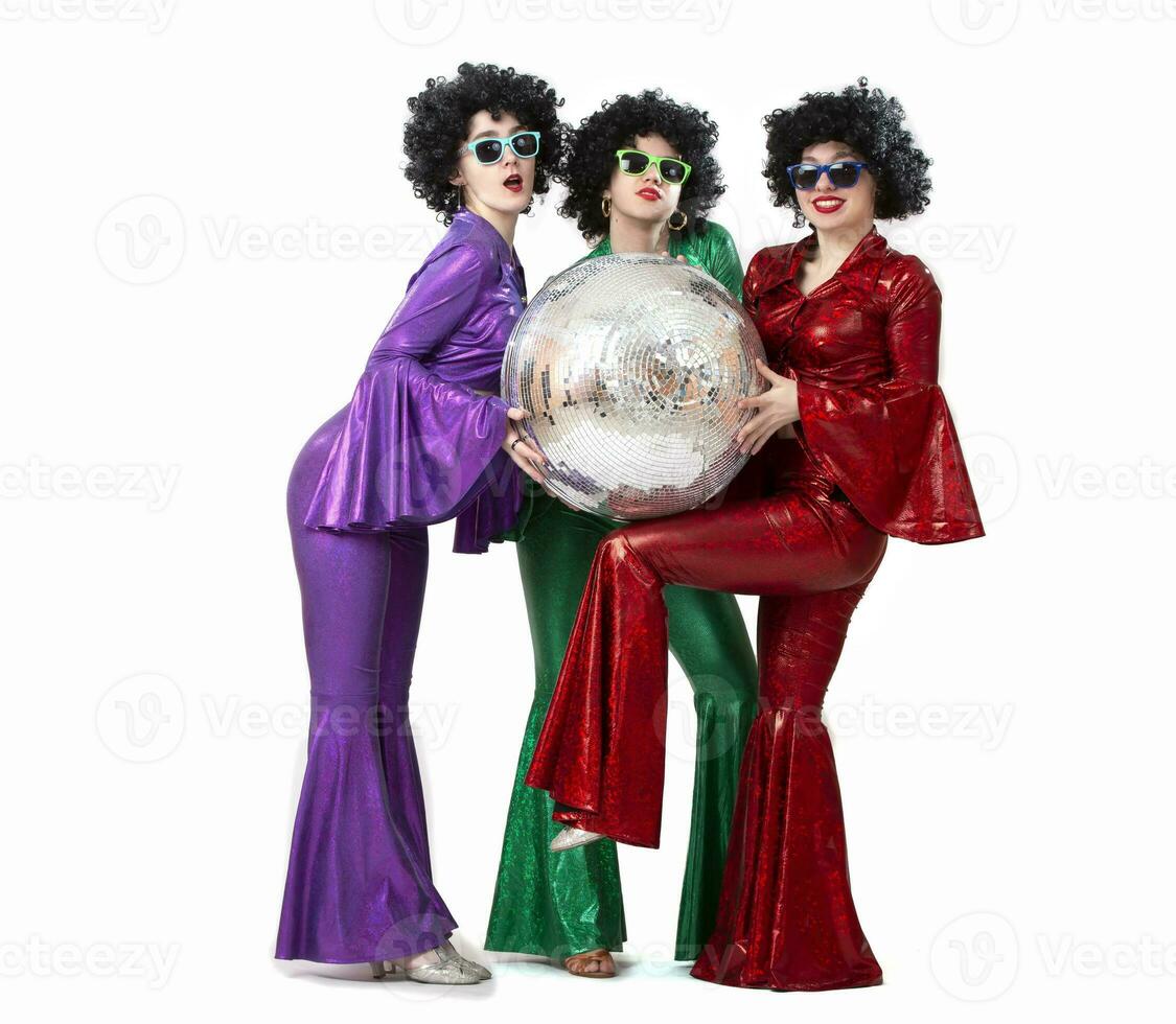 A group of girls with a disco ball in colorful costumes in the fashion style of the seventies or eighties. Disco party on a white background. photo