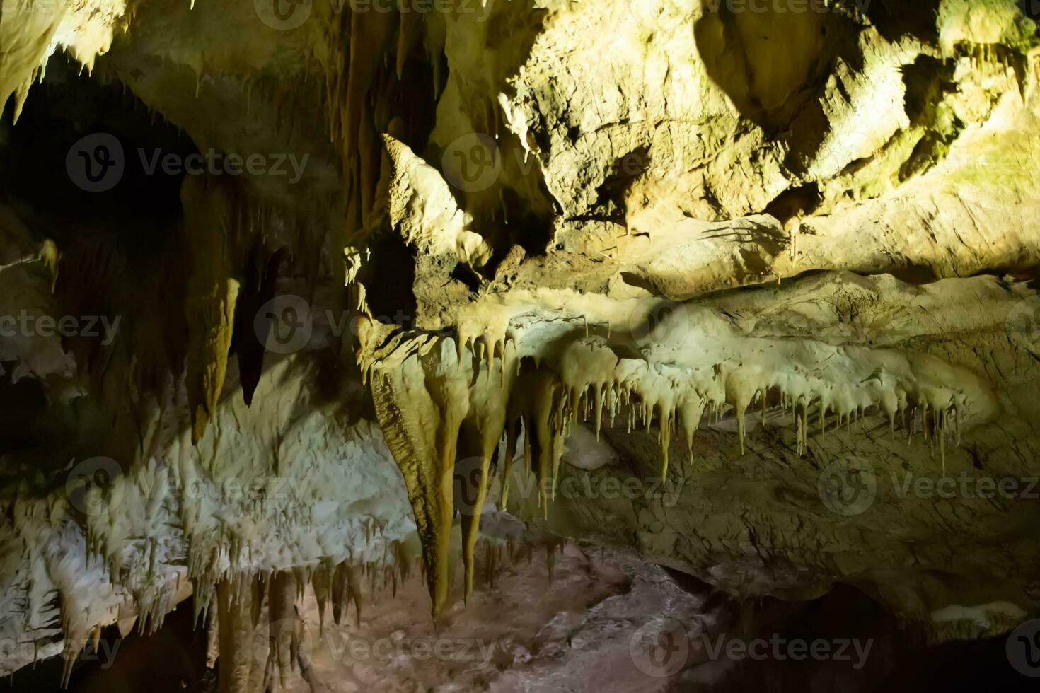The cave is karst, amazing view of stalactites and stalagnites illuminated by bright light, a beautiful natural attraction in a tourist place. photo