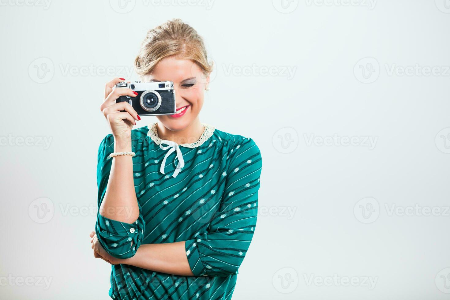 Retro woman photographing with old camera photo