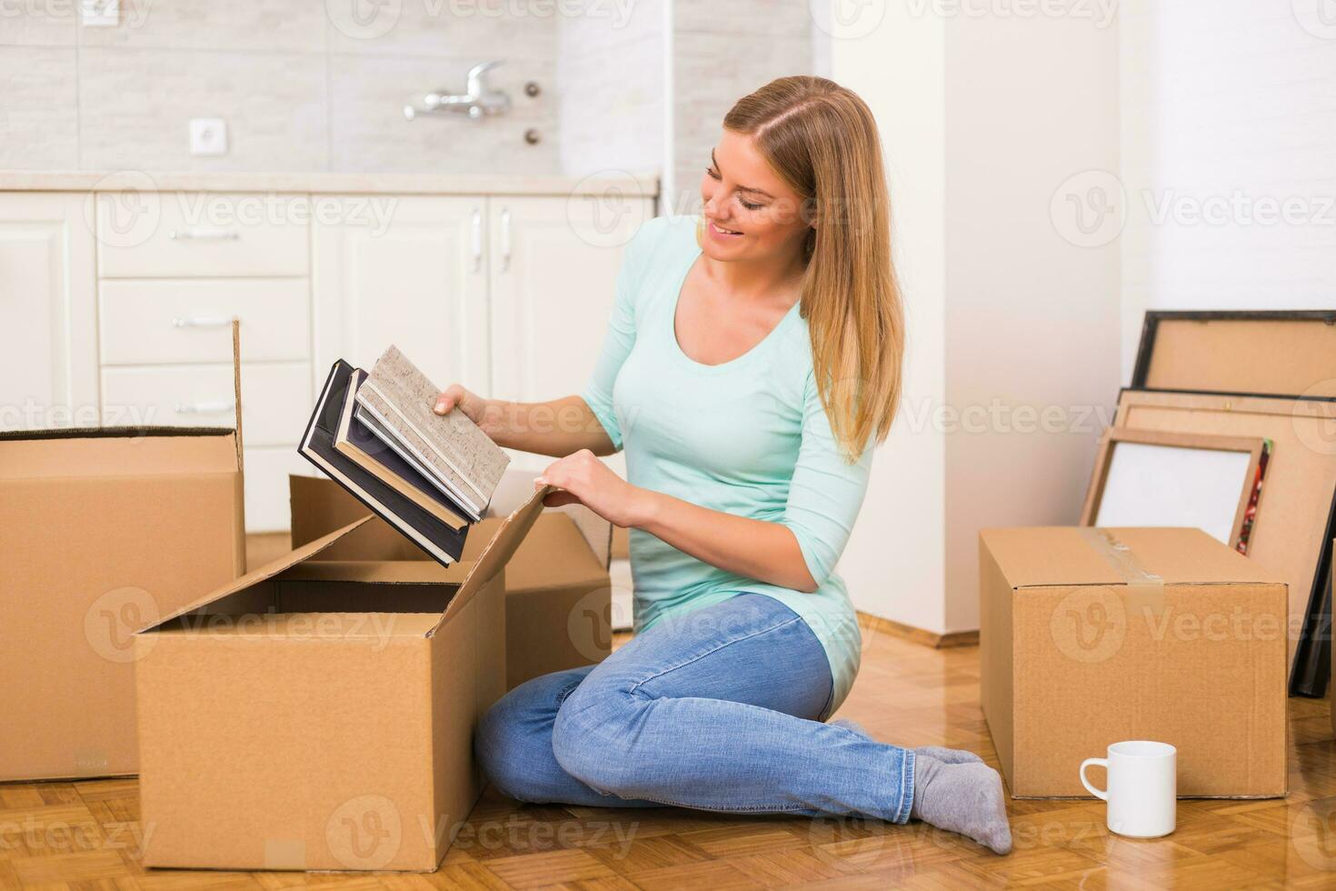 Beautiful woman moving into new home. photo