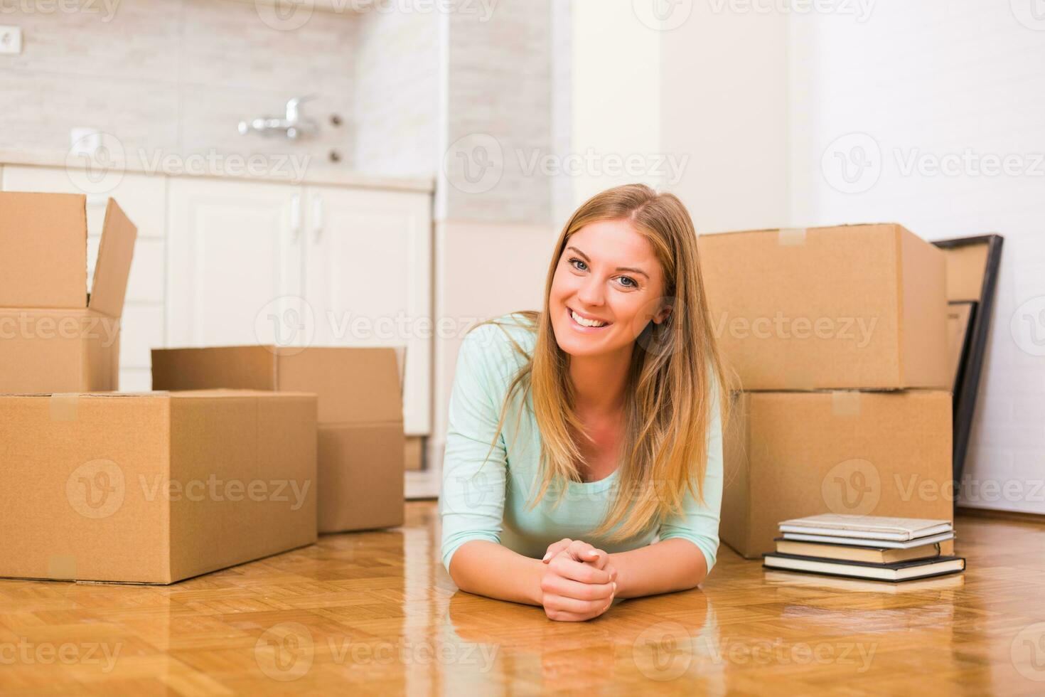 Beautiful woman moving into new apartment. photo