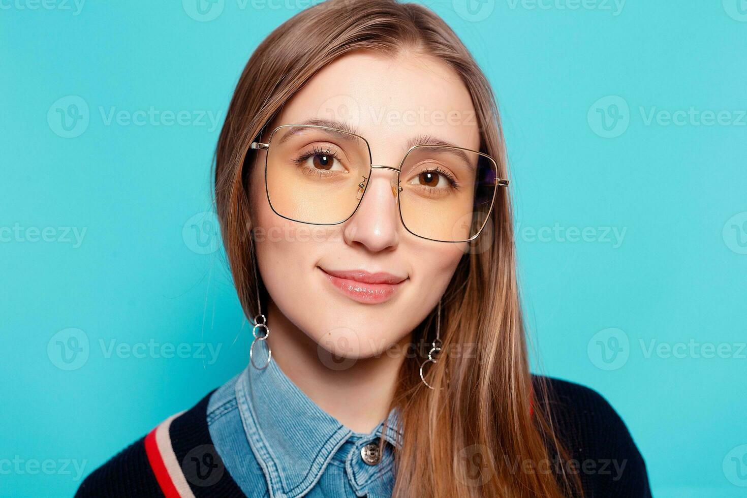 Close up shot of stylish young woman in sunglasses smiling photo