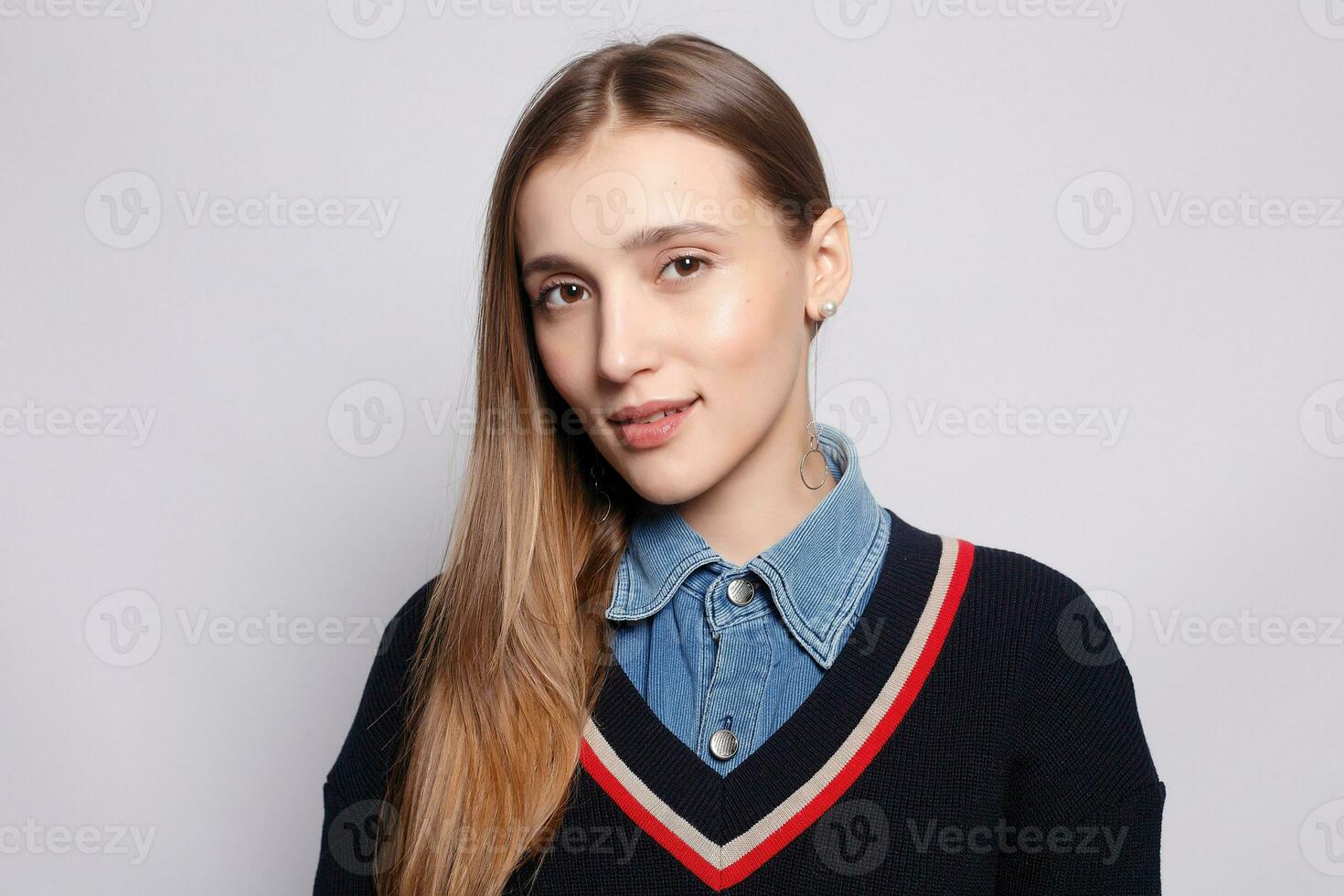 Pretty smiling joyfully female with fair hair, dressed casually photo