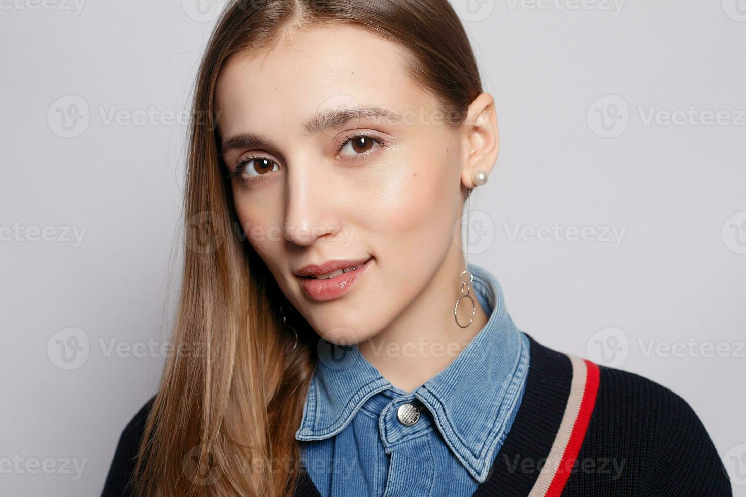 Pretty smiling joyfully female with fair hair, dressed casually photo