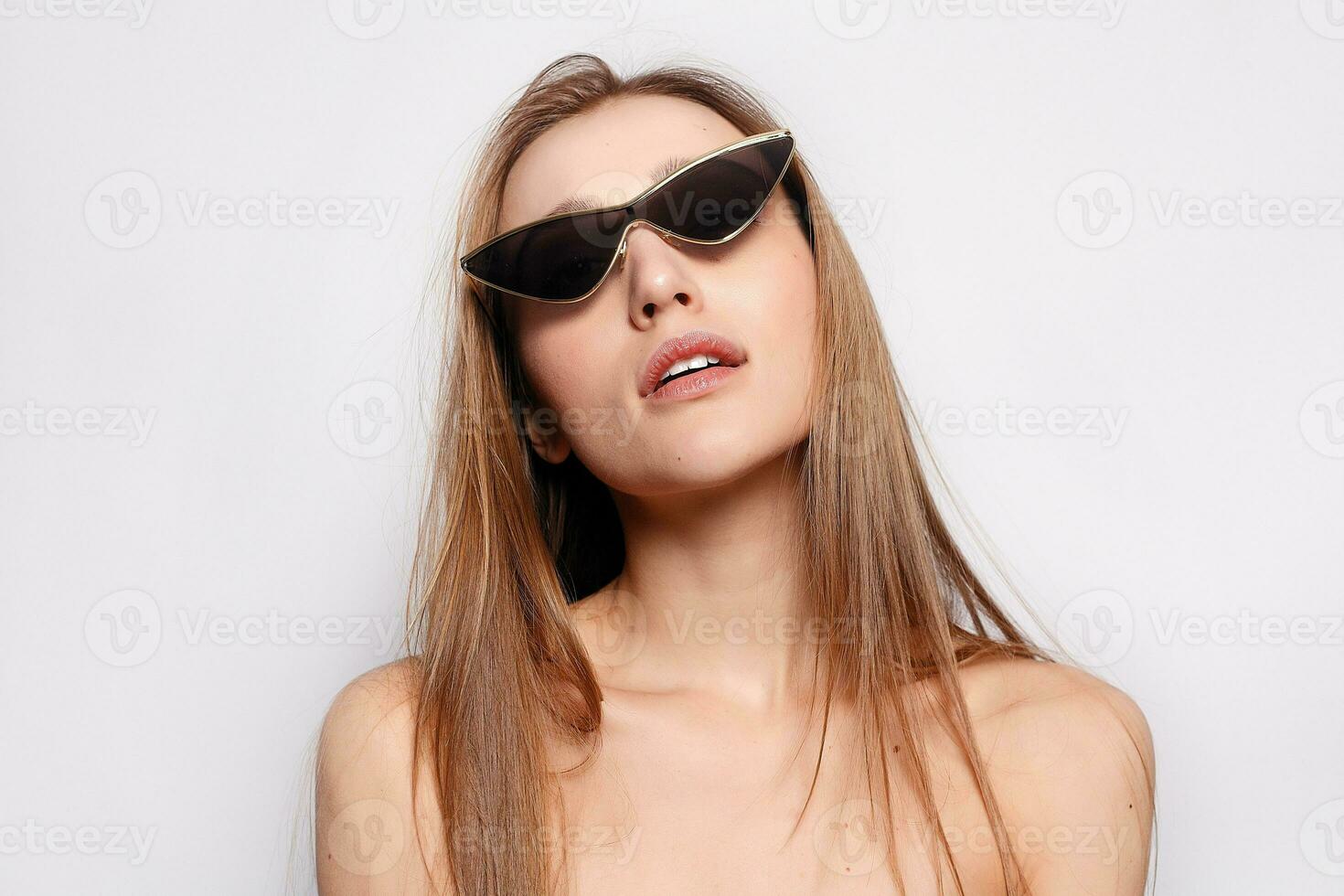 Close up shot of stylish young woman in sunglasses smiling photo