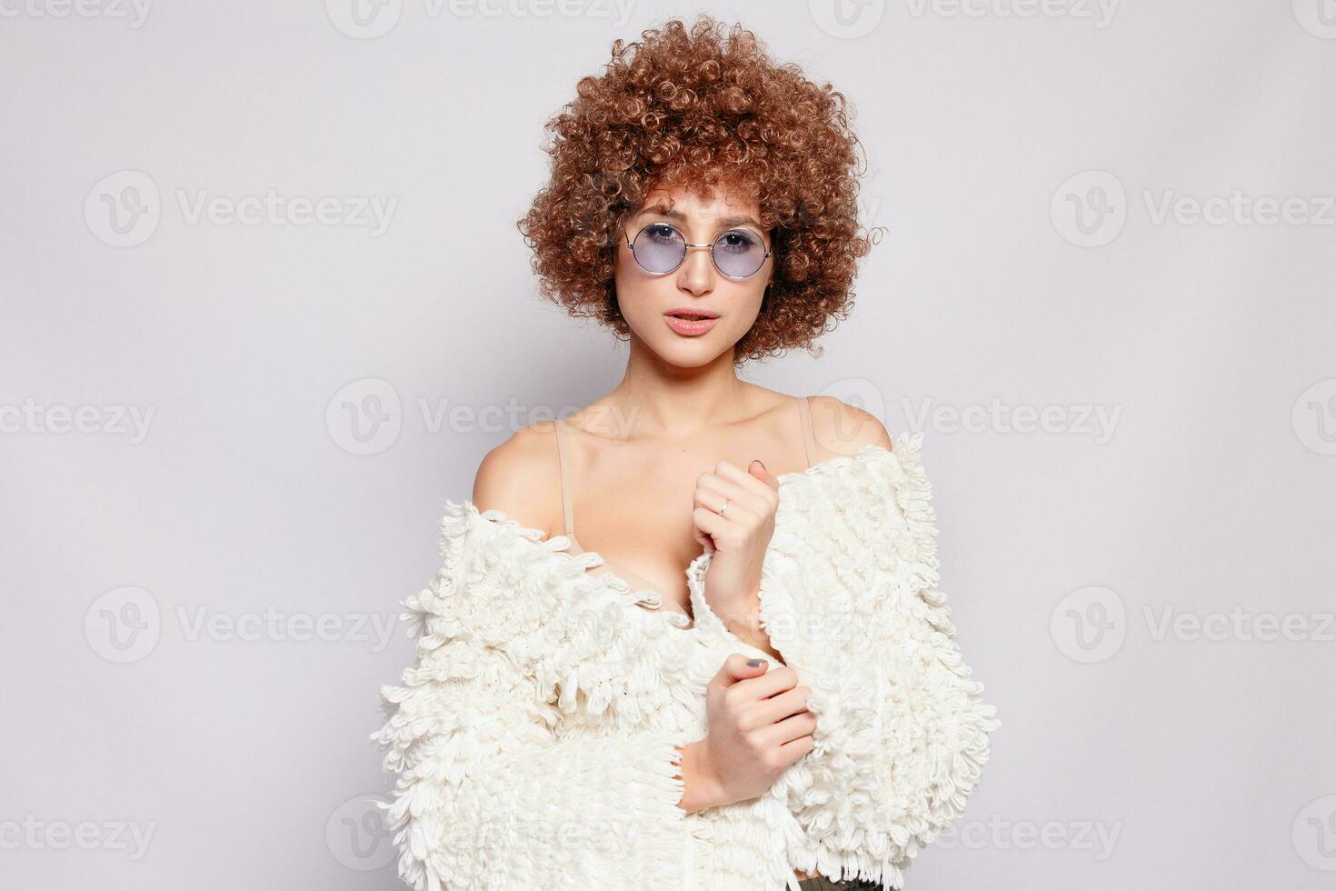 Portrait of smiling young woman with afro hairstyle photo