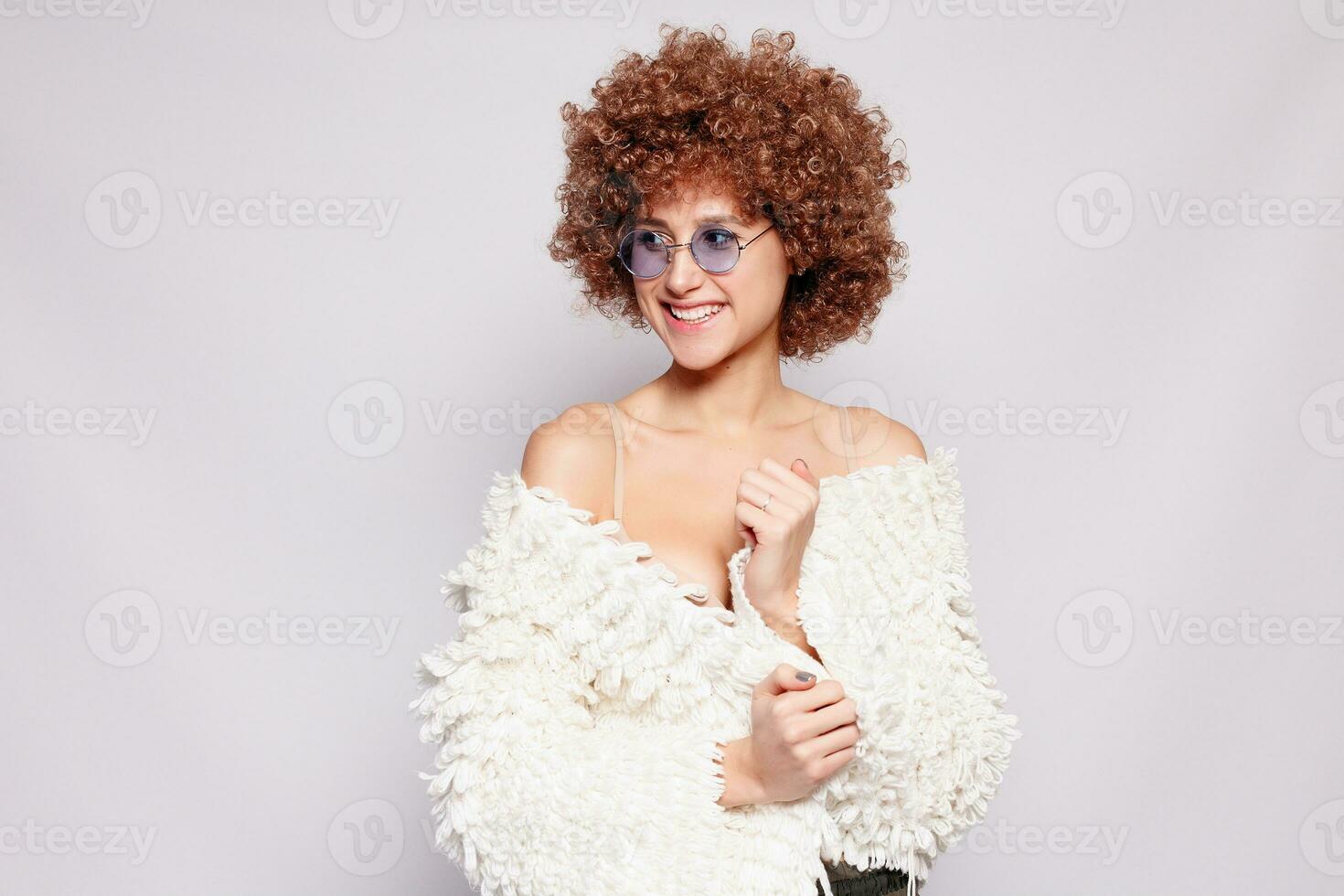 Portrait of smiling young woman with afro hairstyle photo