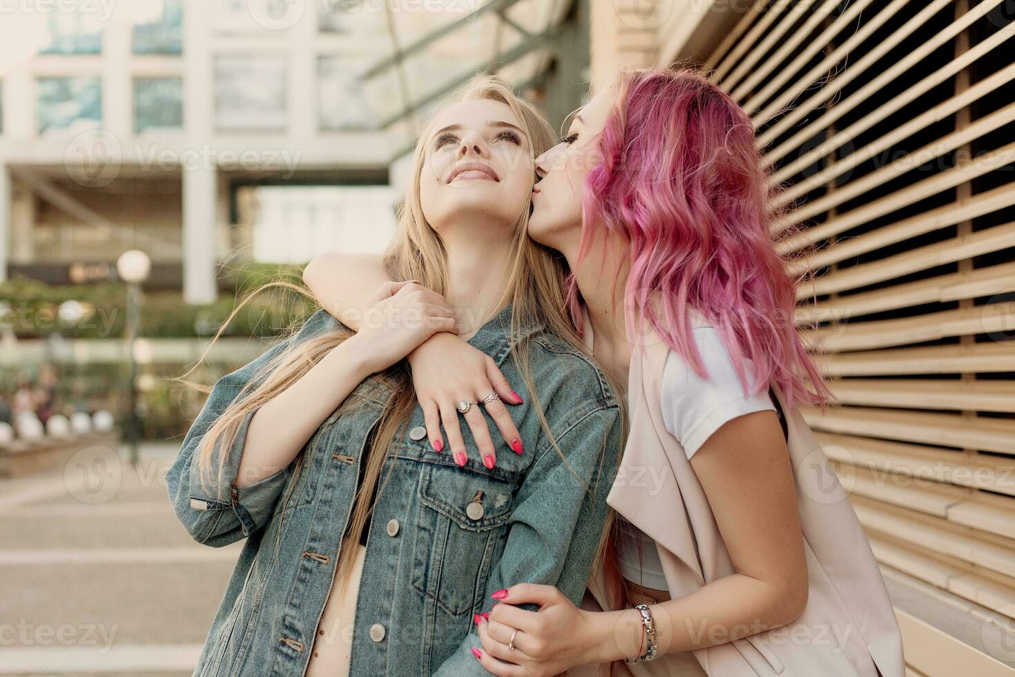 Two young women laughing and walking enjoying carefree vacation lifestyle photo