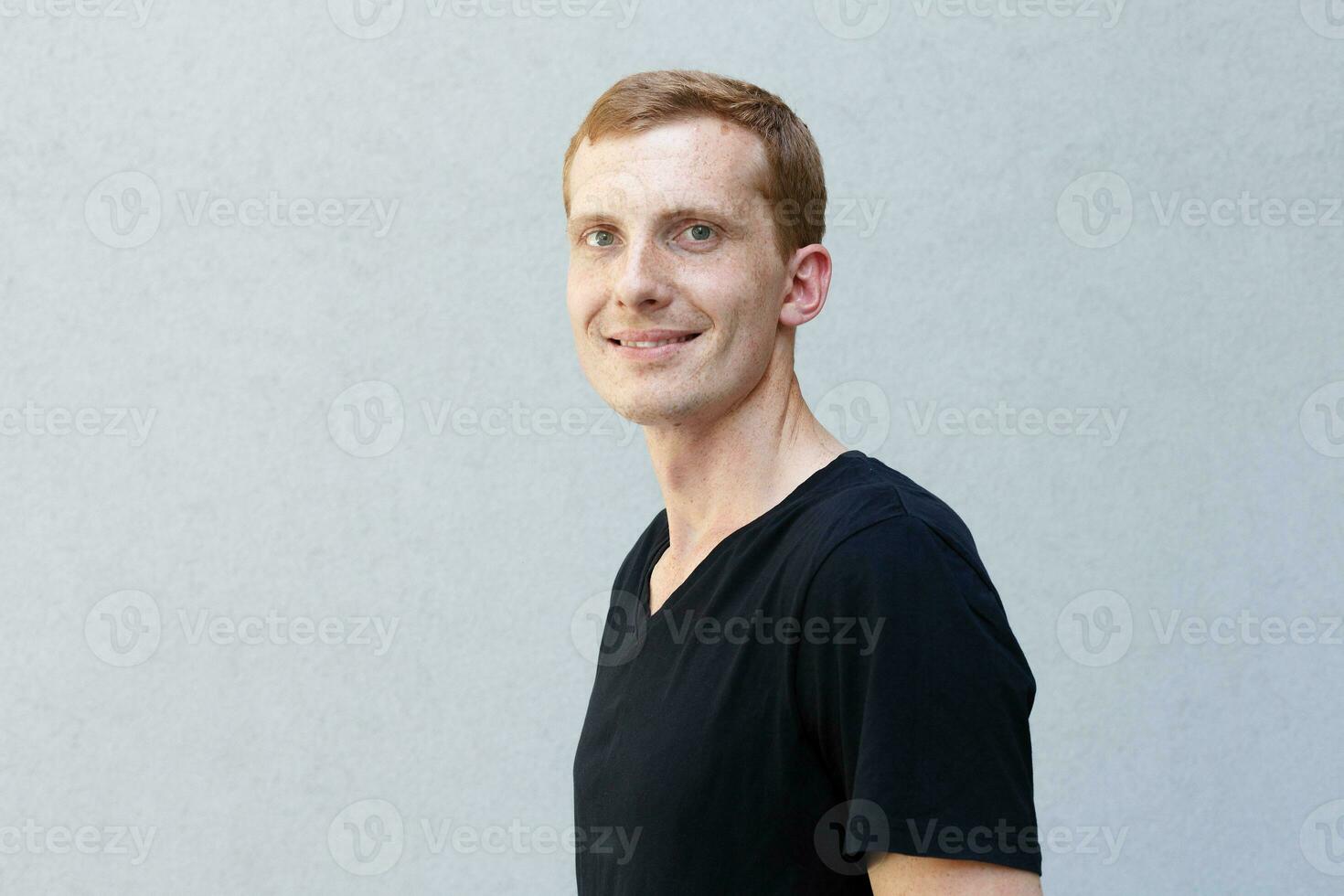 Close up portrait of a redhead of a beautiful manly guy with freckles photo