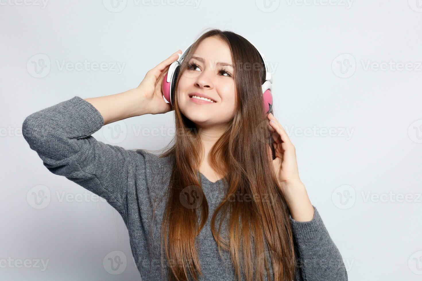 happy woman or teenage girl in headphones listening to music photo