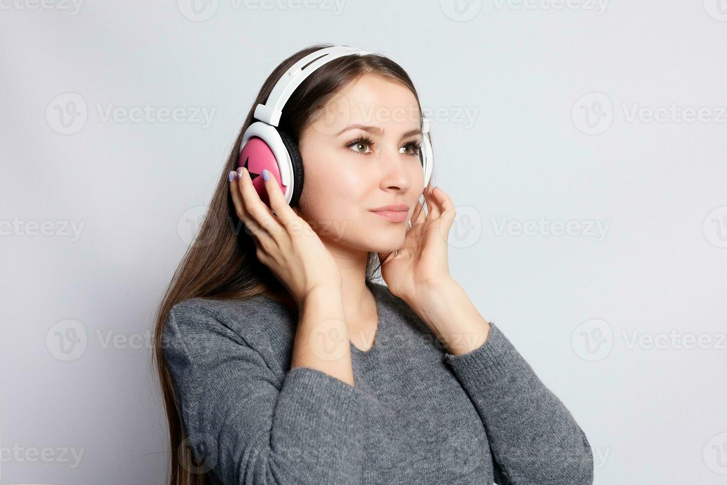 happy woman or teenage girl in headphones listening to music photo