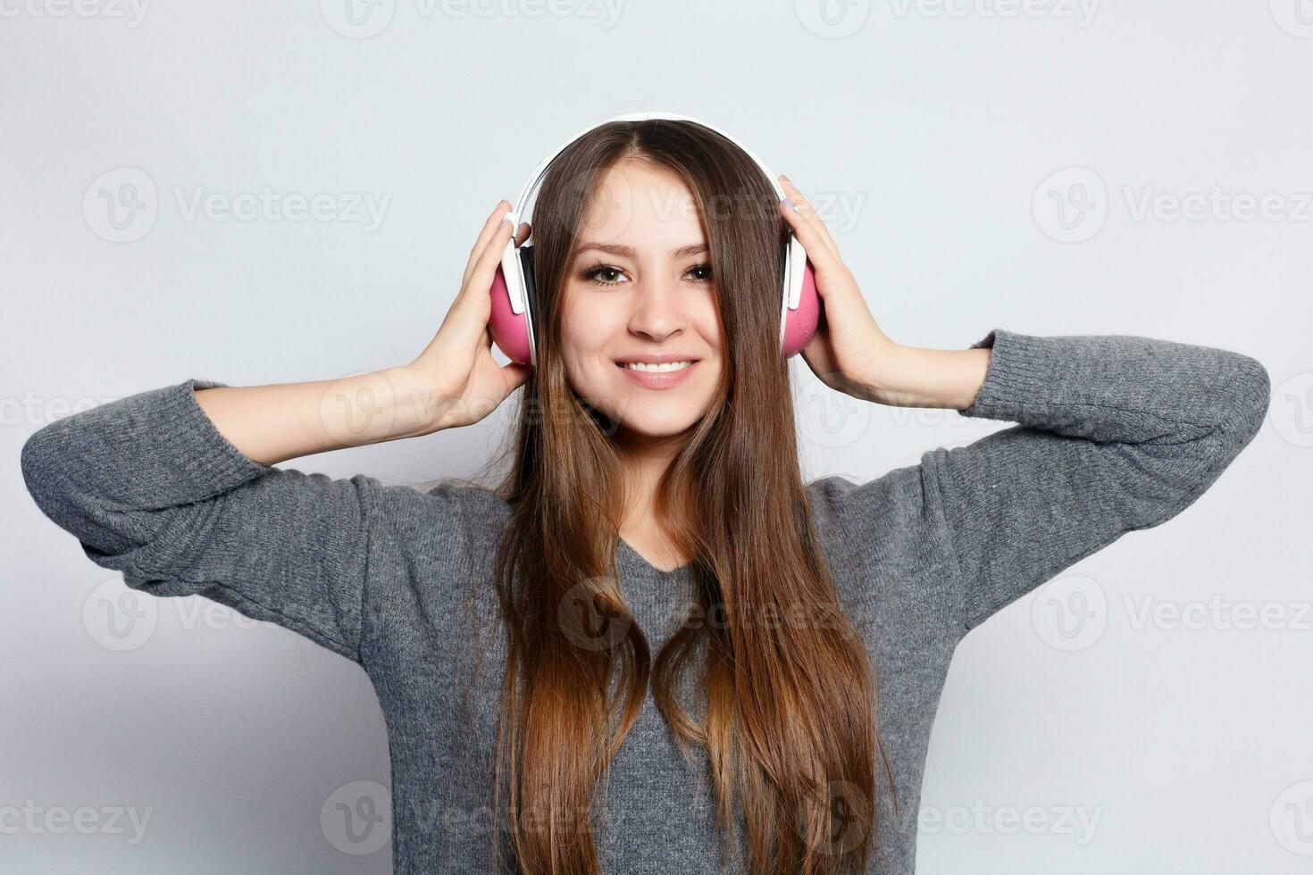 happy woman or teenage girl in headphones listening to music photo