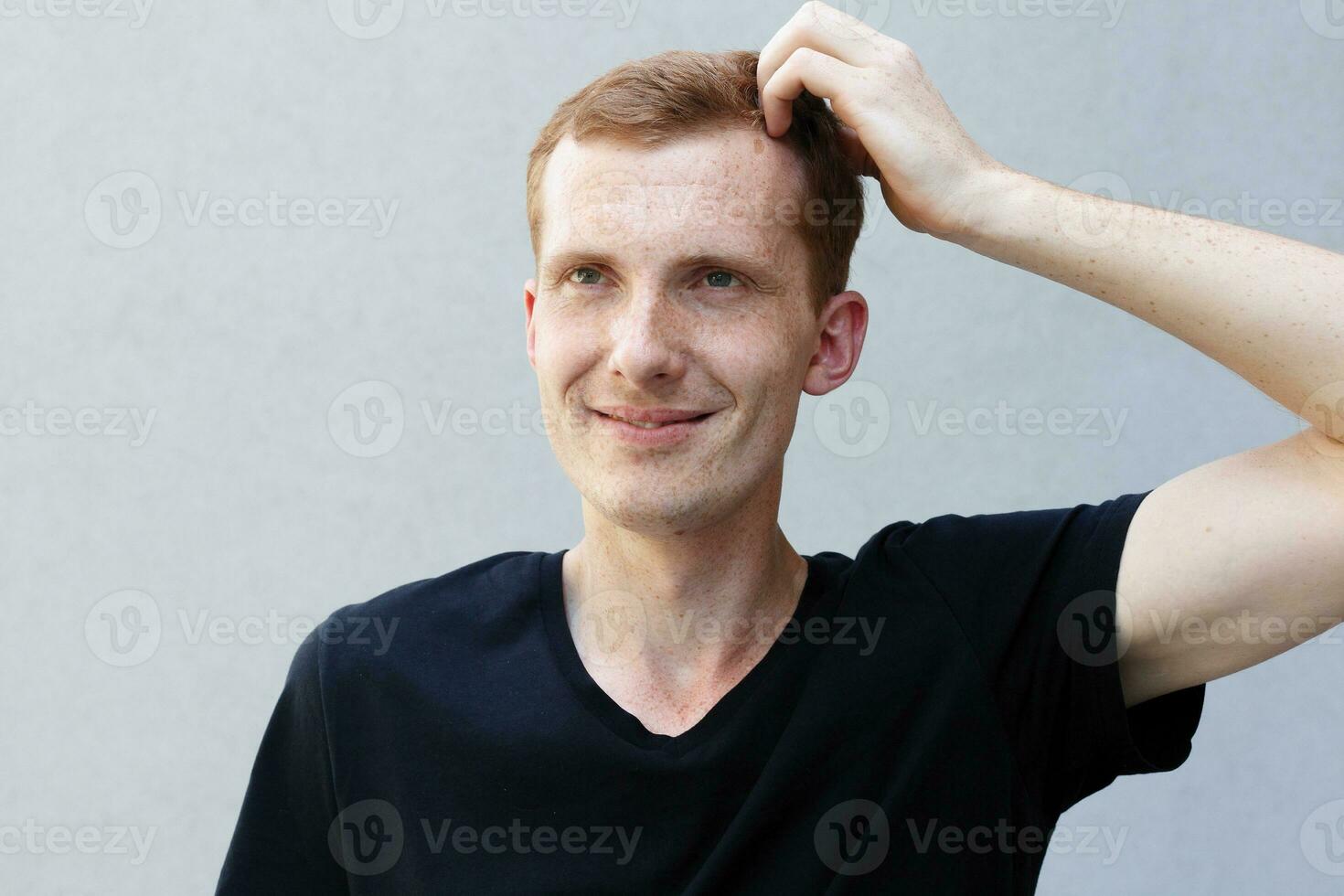 Close up portrait of a redhead of a beautiful manly guy with freckles photo