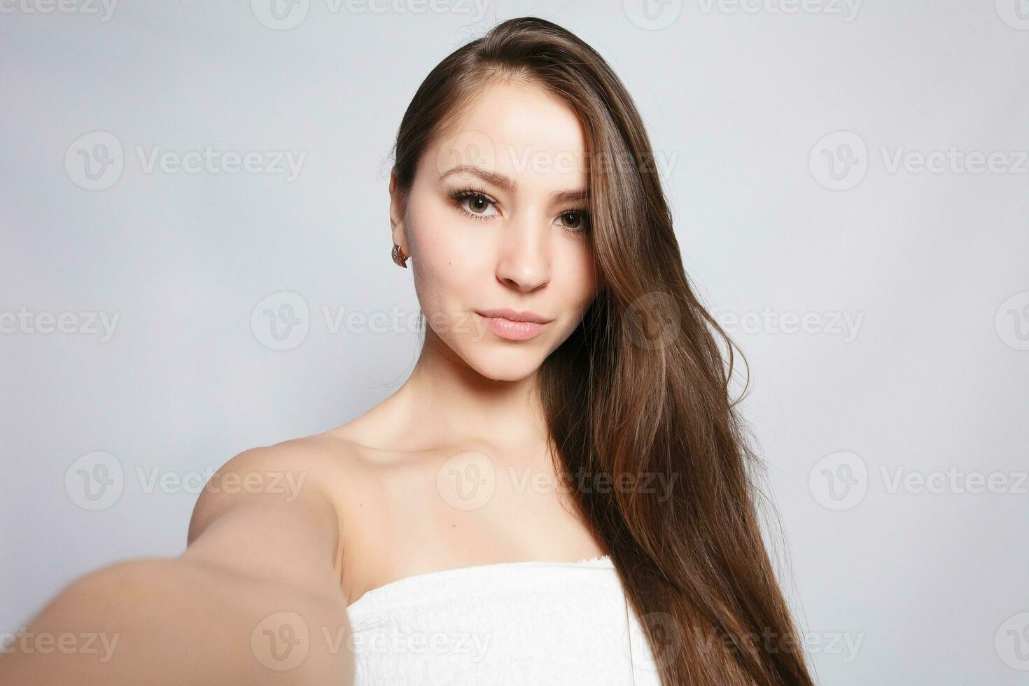 Spa Woman. Beautiful Girl After Bath Touching Her Face. photo